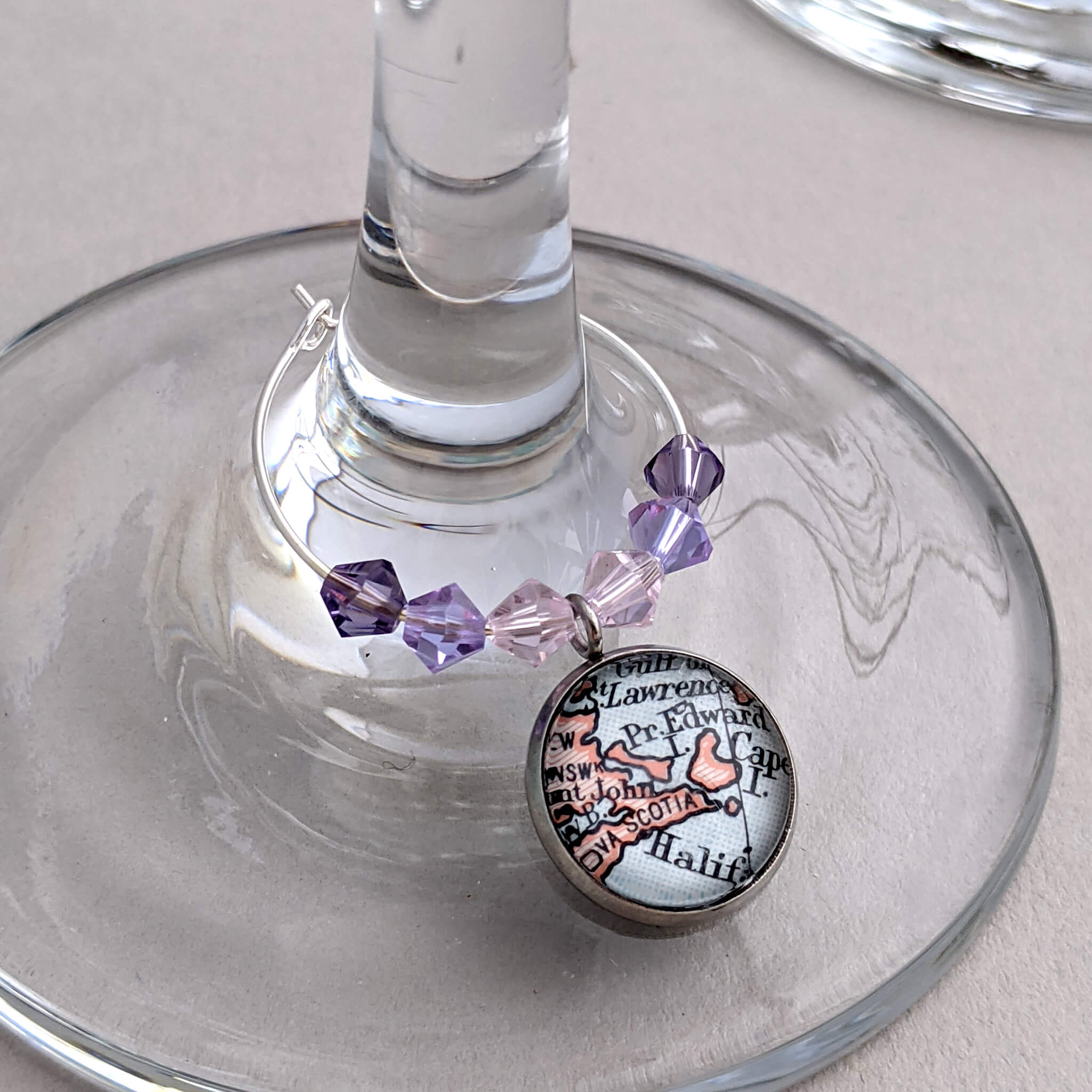 wine glass charm in pink and violet tones personalised with map of Halifax