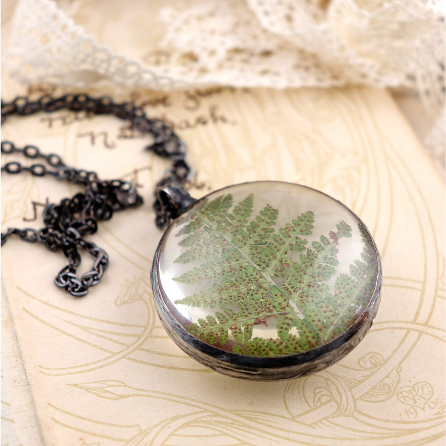 Pressed fern closed in glass necklace on black chain