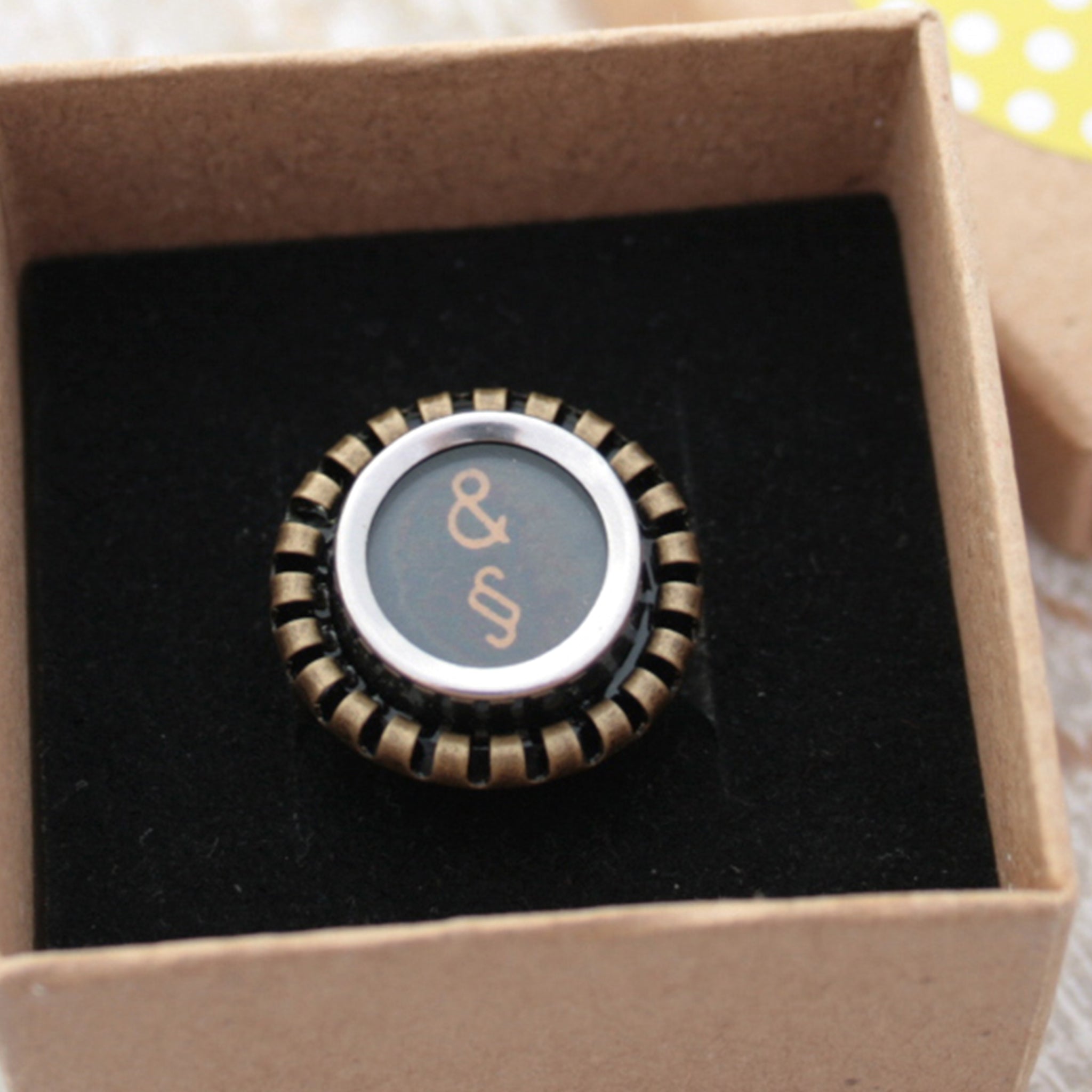 Black Ring featuring Amresand and paragraph signs made of typewriter key in a box