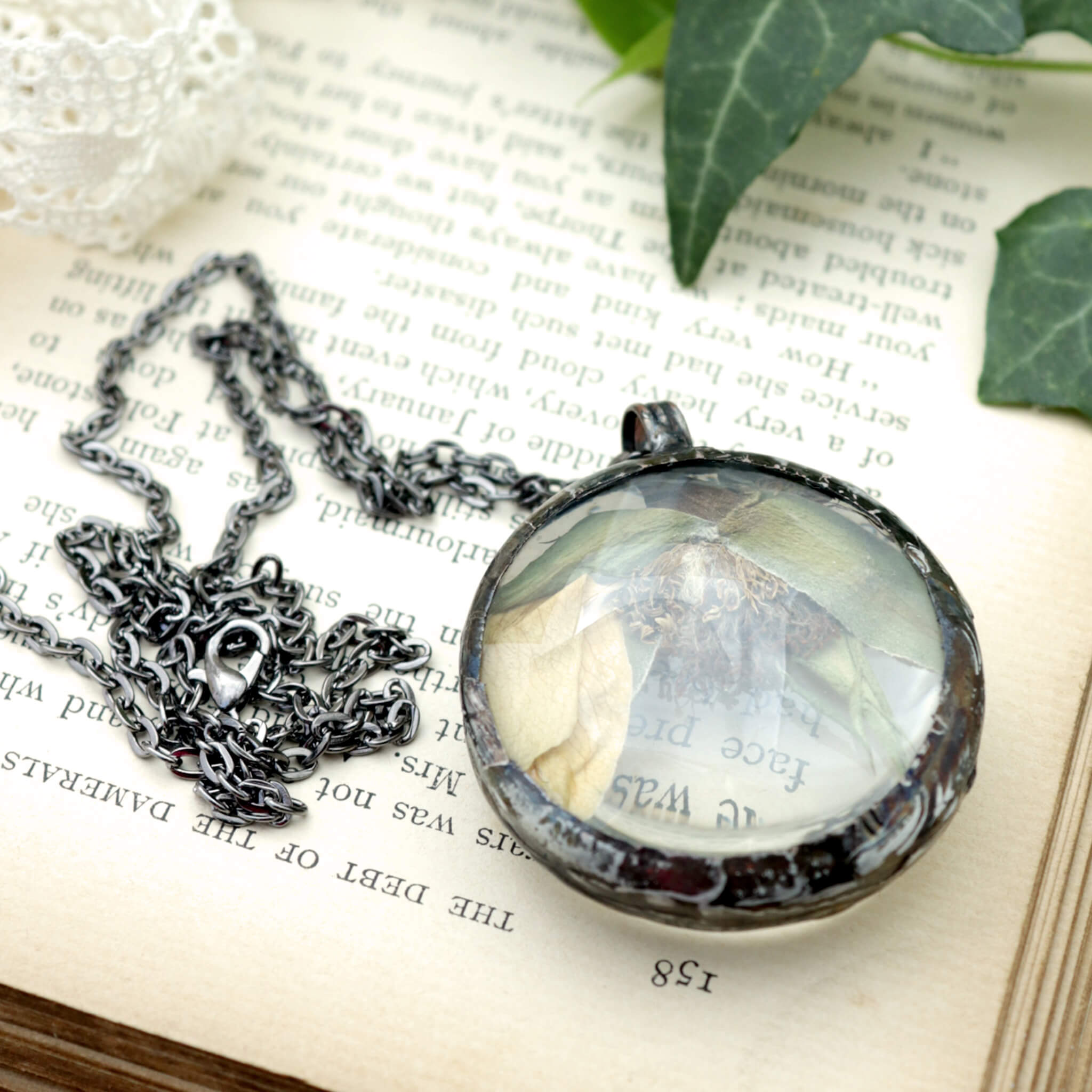 Withered rose necklace lying on a vintage book