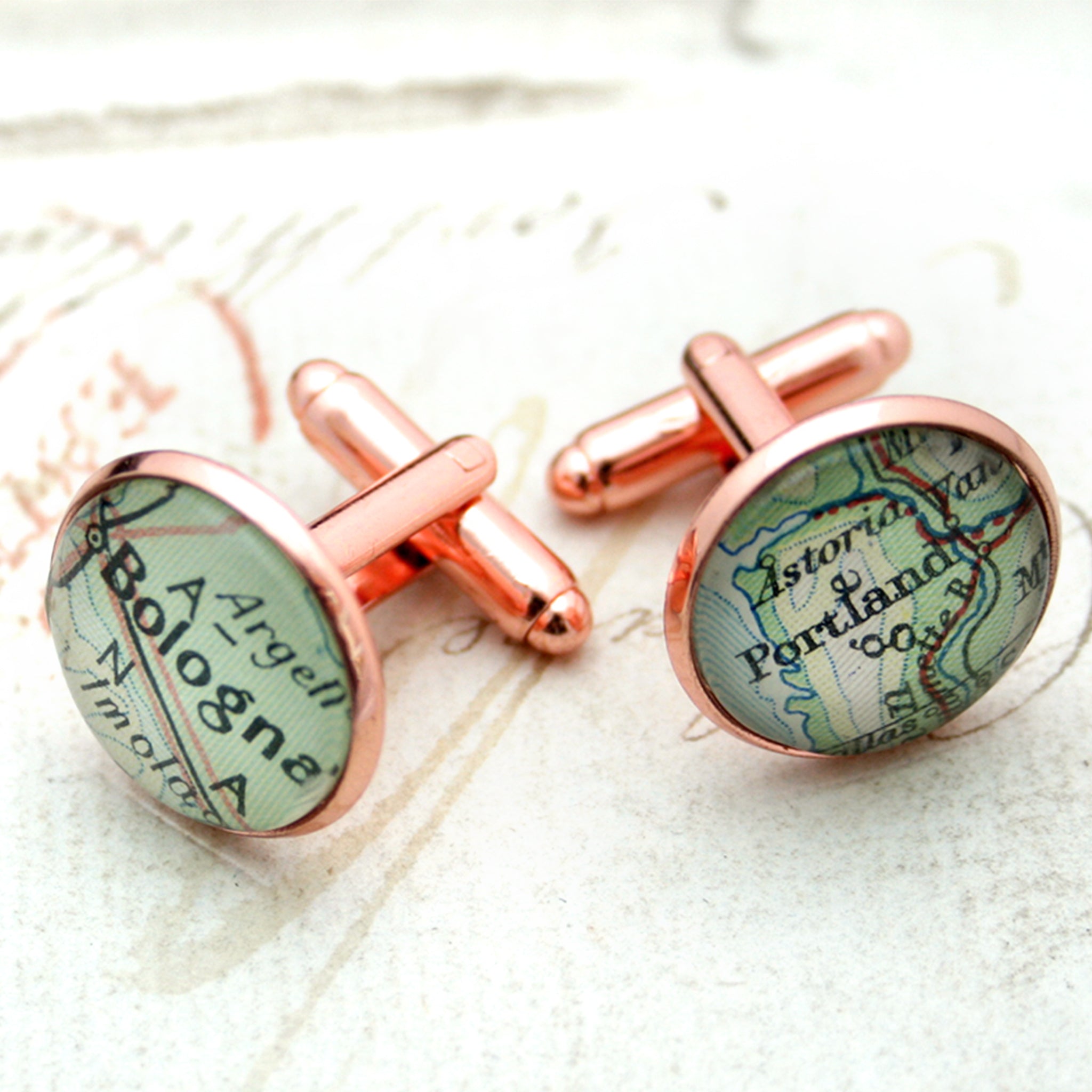 Personalised map cufflinks in rose gold color featuring Bologna and Portland