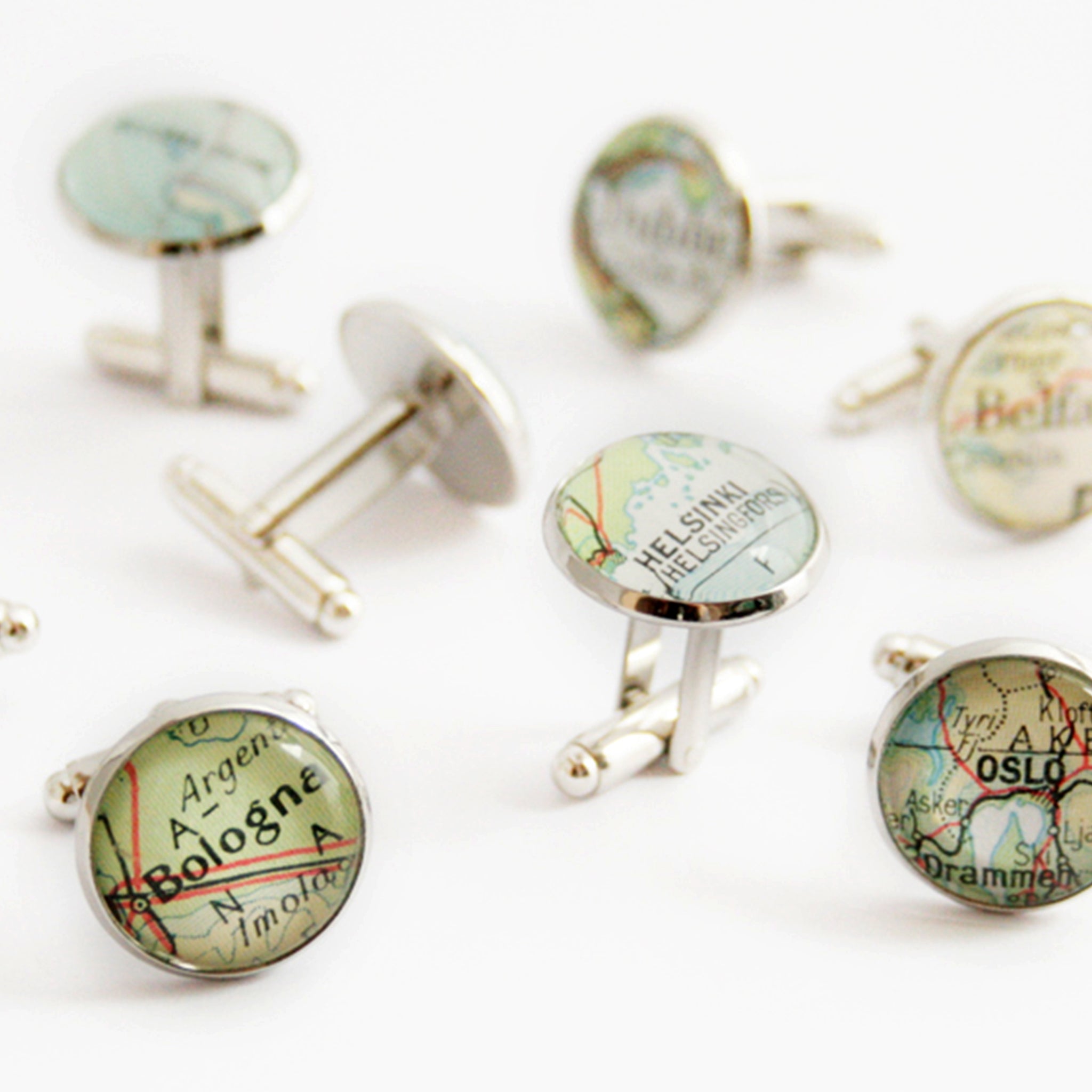 Many sets of Personalised map cufflinks in silver tone featuring custom maps
