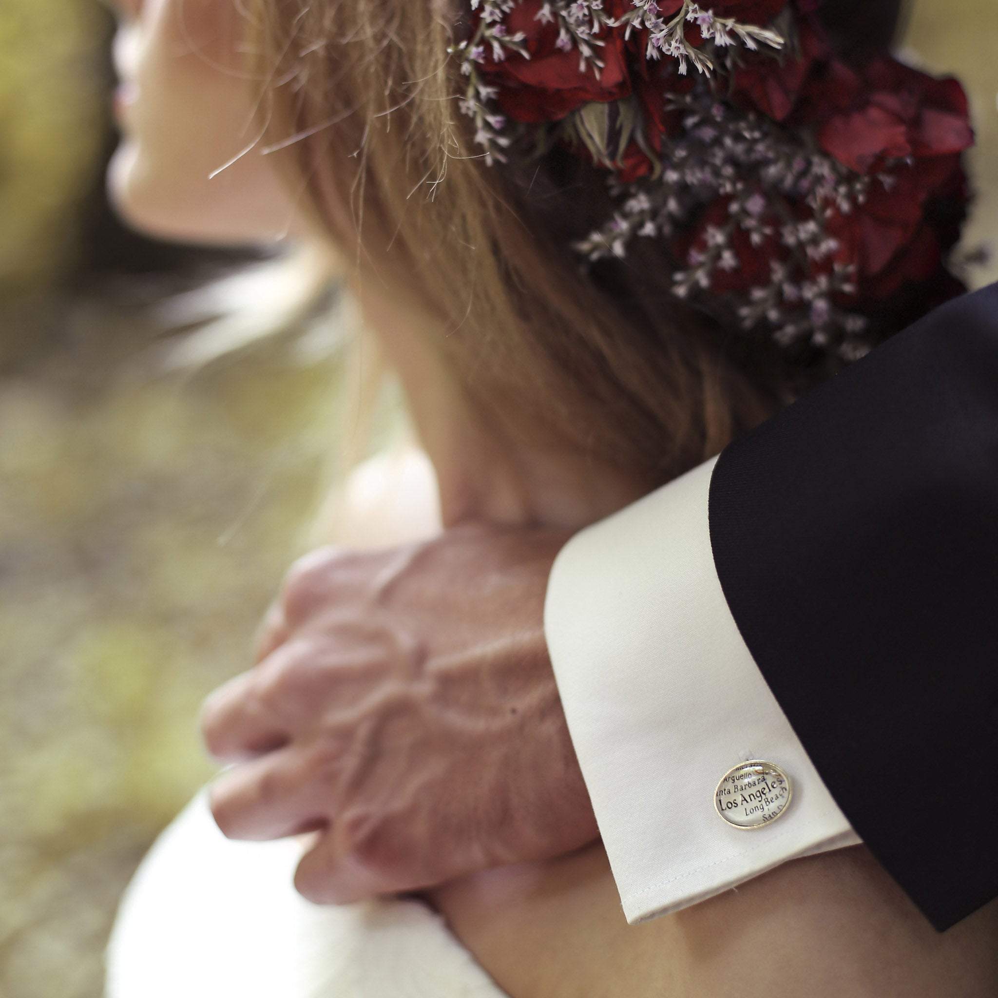 Groom holds his hand on a Bride's shoulder