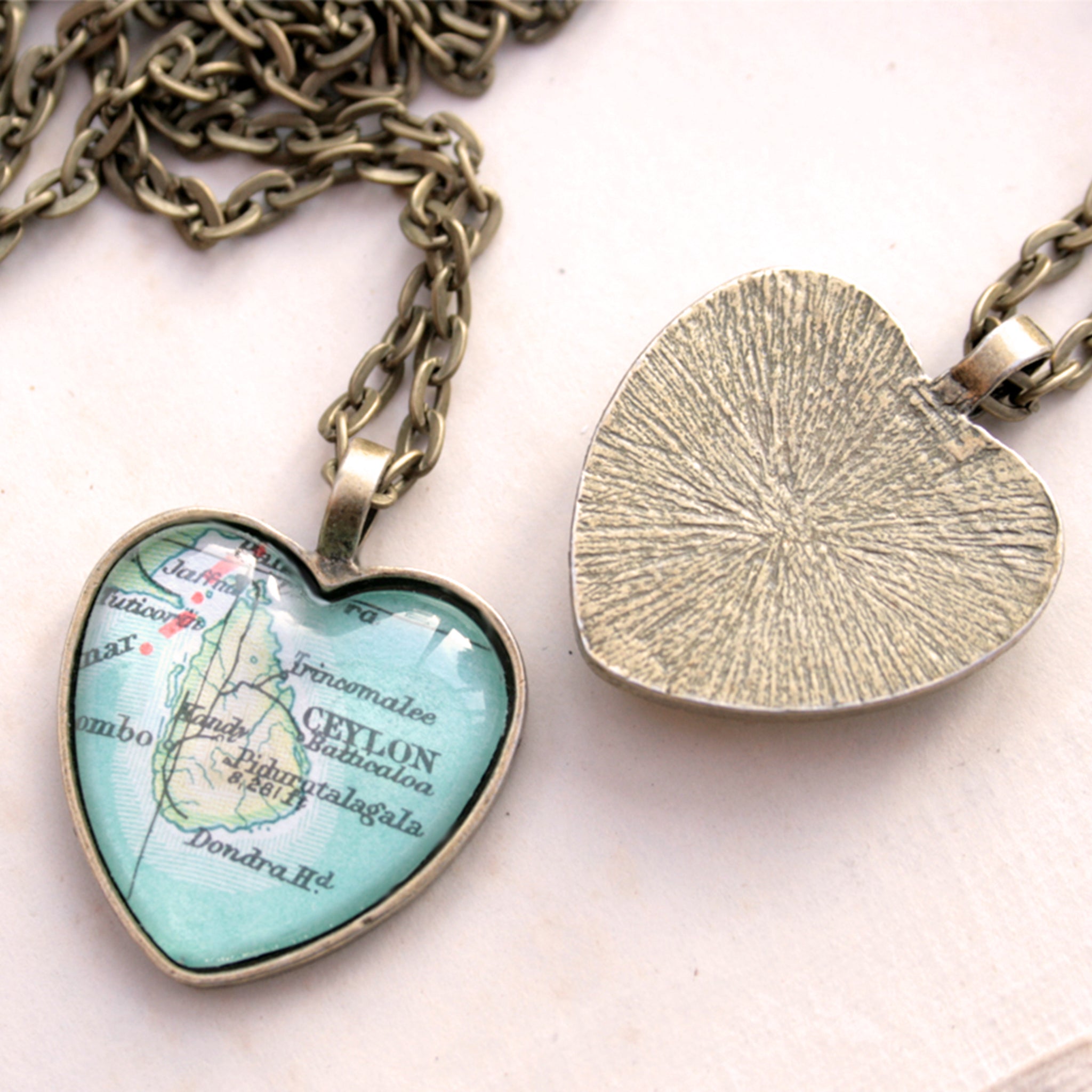 Heart shaped pendant necklace in bronze tone featuring map of Ceylon