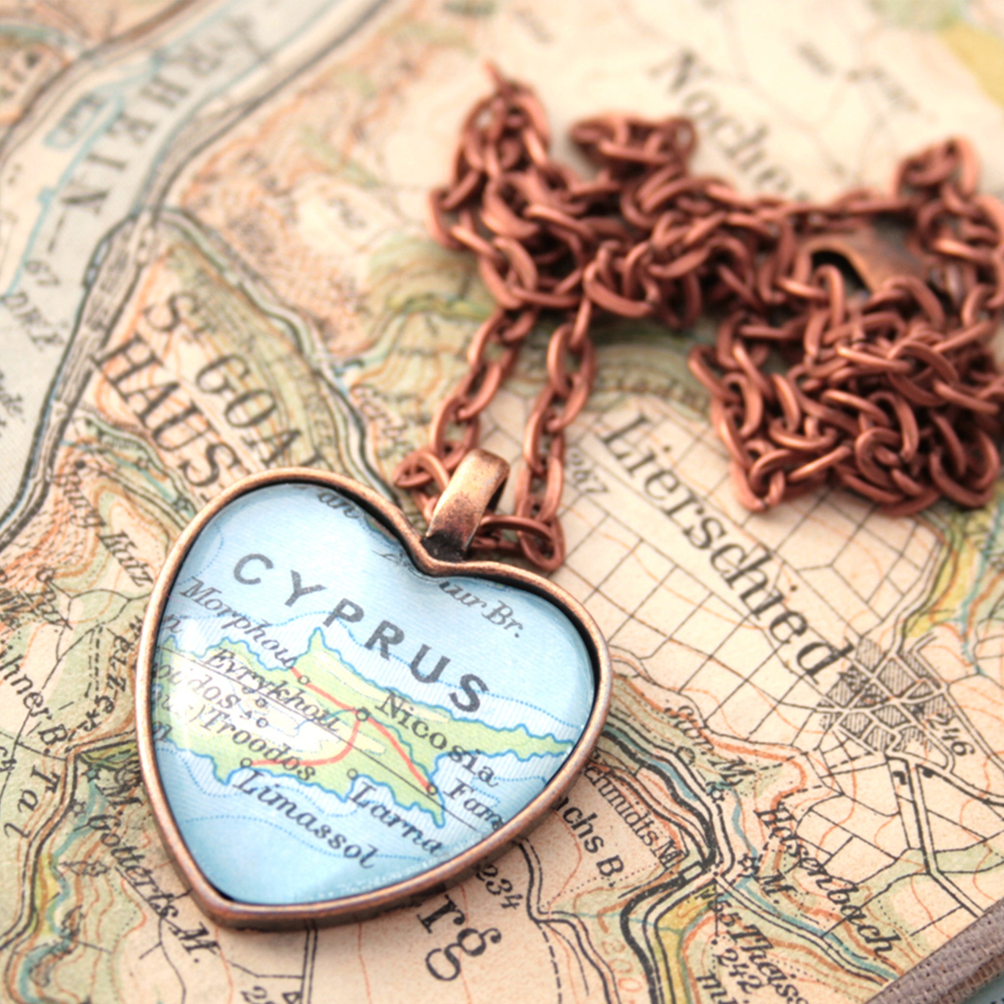 Heart shaped pendant necklace in copper tone featuring map of Cyprus