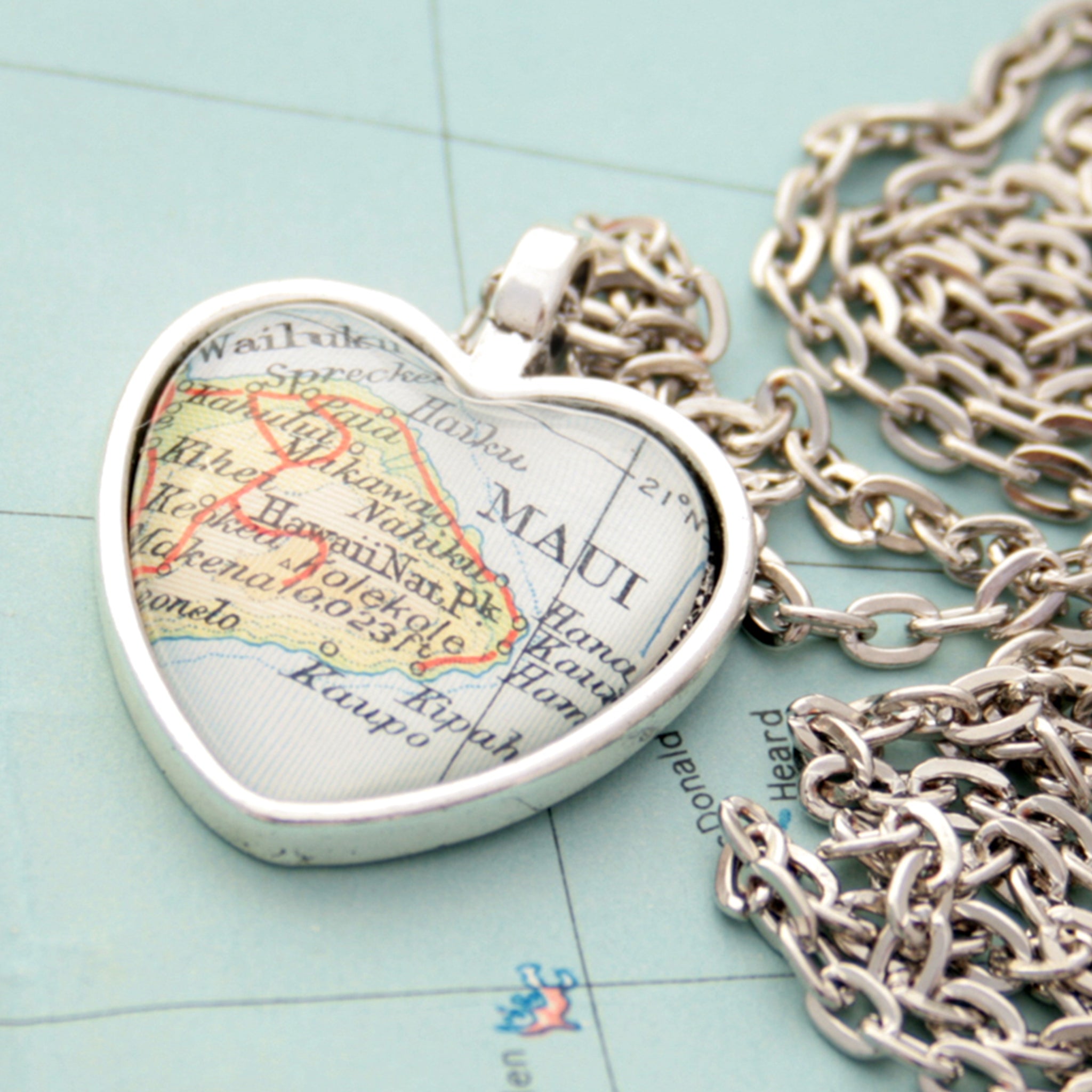 Heart shaped pendant necklace in silver tone featuring map of Maui