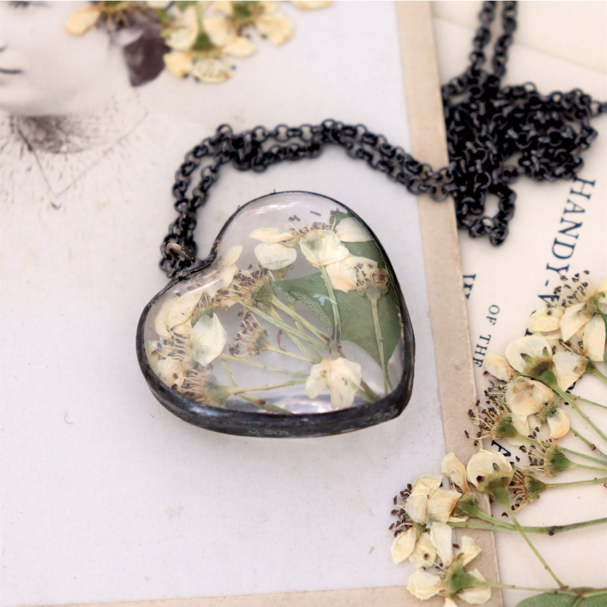 oval hawthorn necklace lying on a vintage photograph