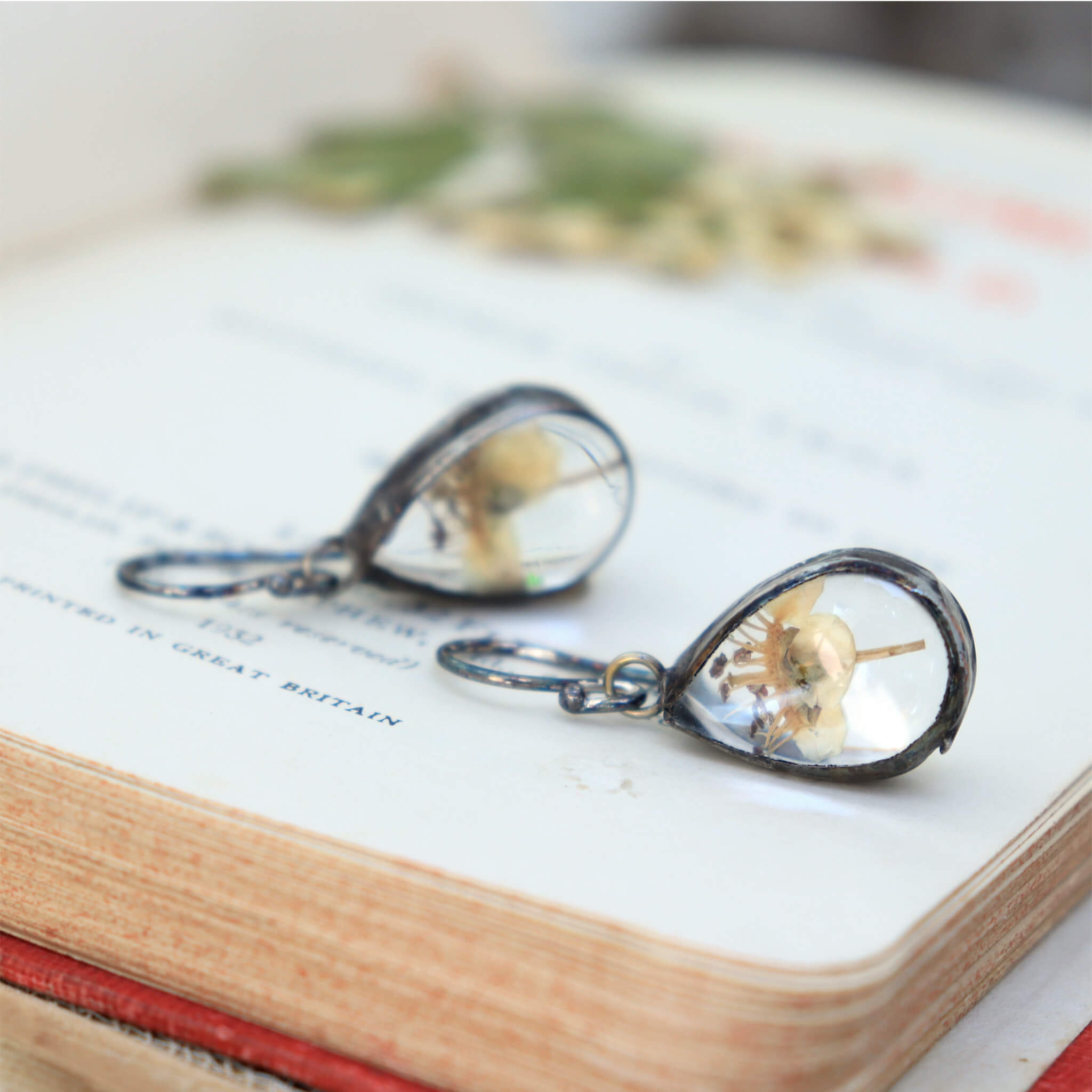 oval hawthorn earrings lying on a vintage book