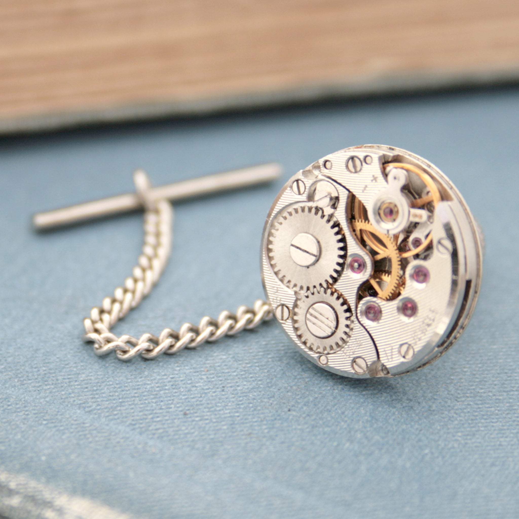 Tie tack with chain made of old watch movement