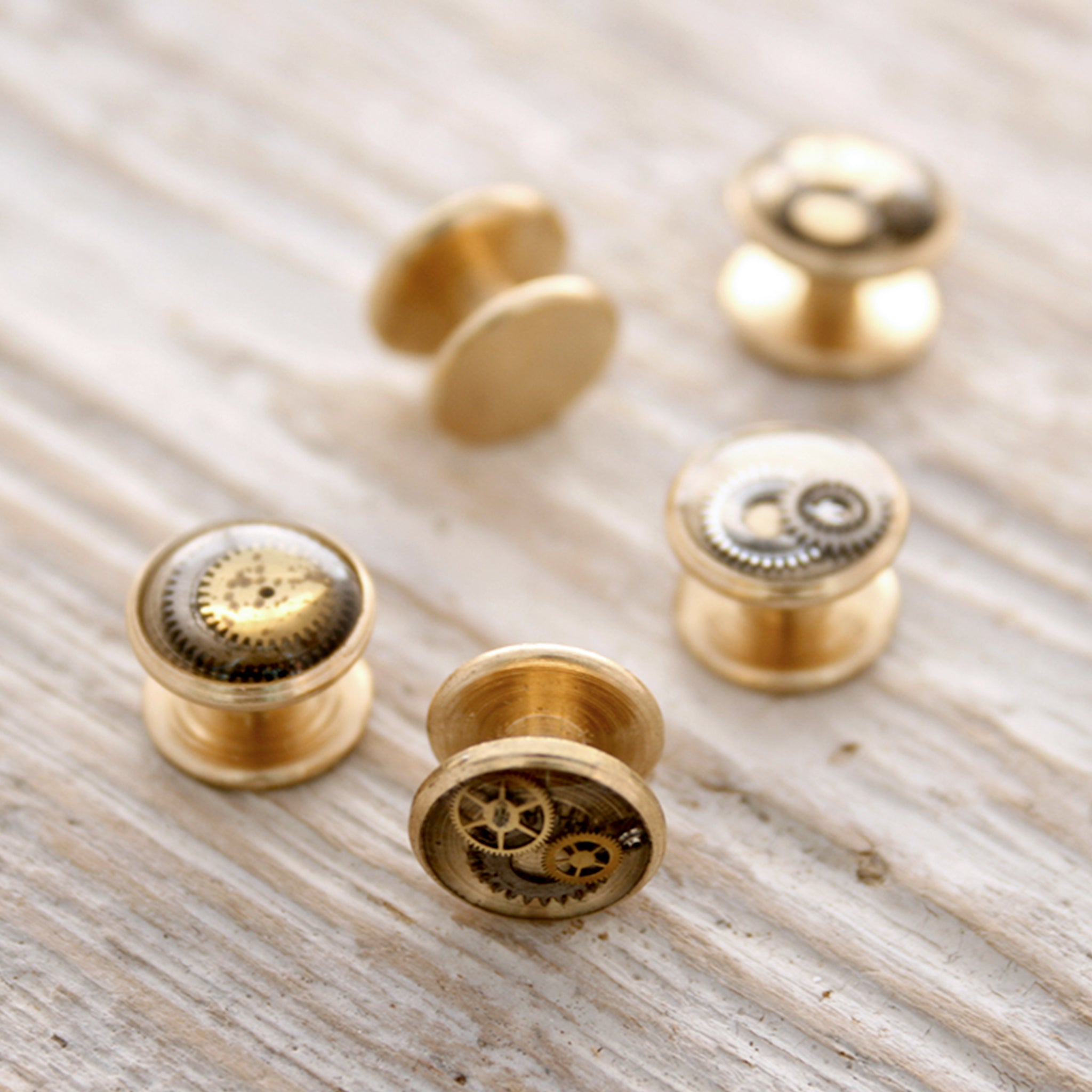 Little tuxedo studs made of raw brass, watch parts and resin