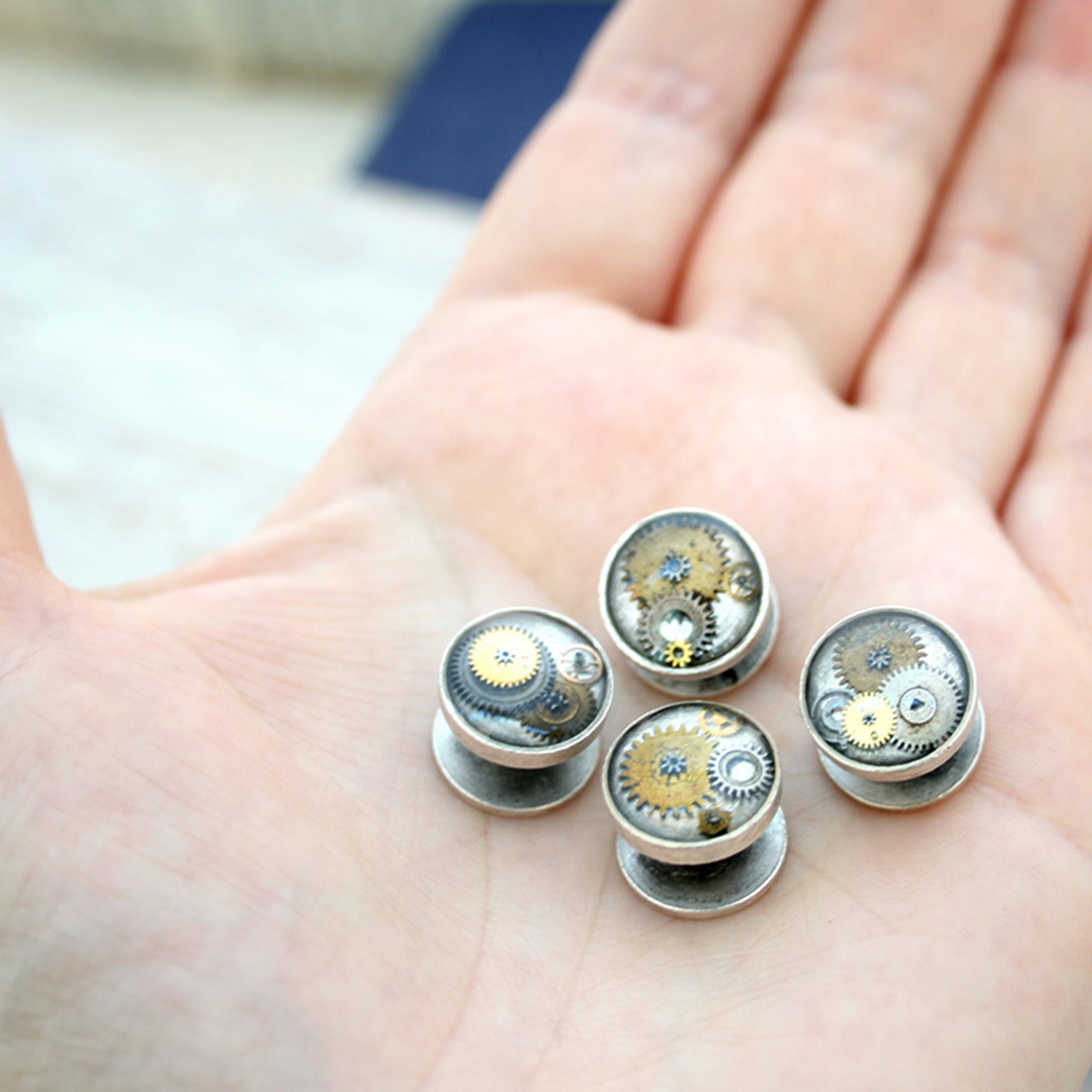Antique Silver tone tuxedo studs featuring vintage watch parts filled with resin on hand