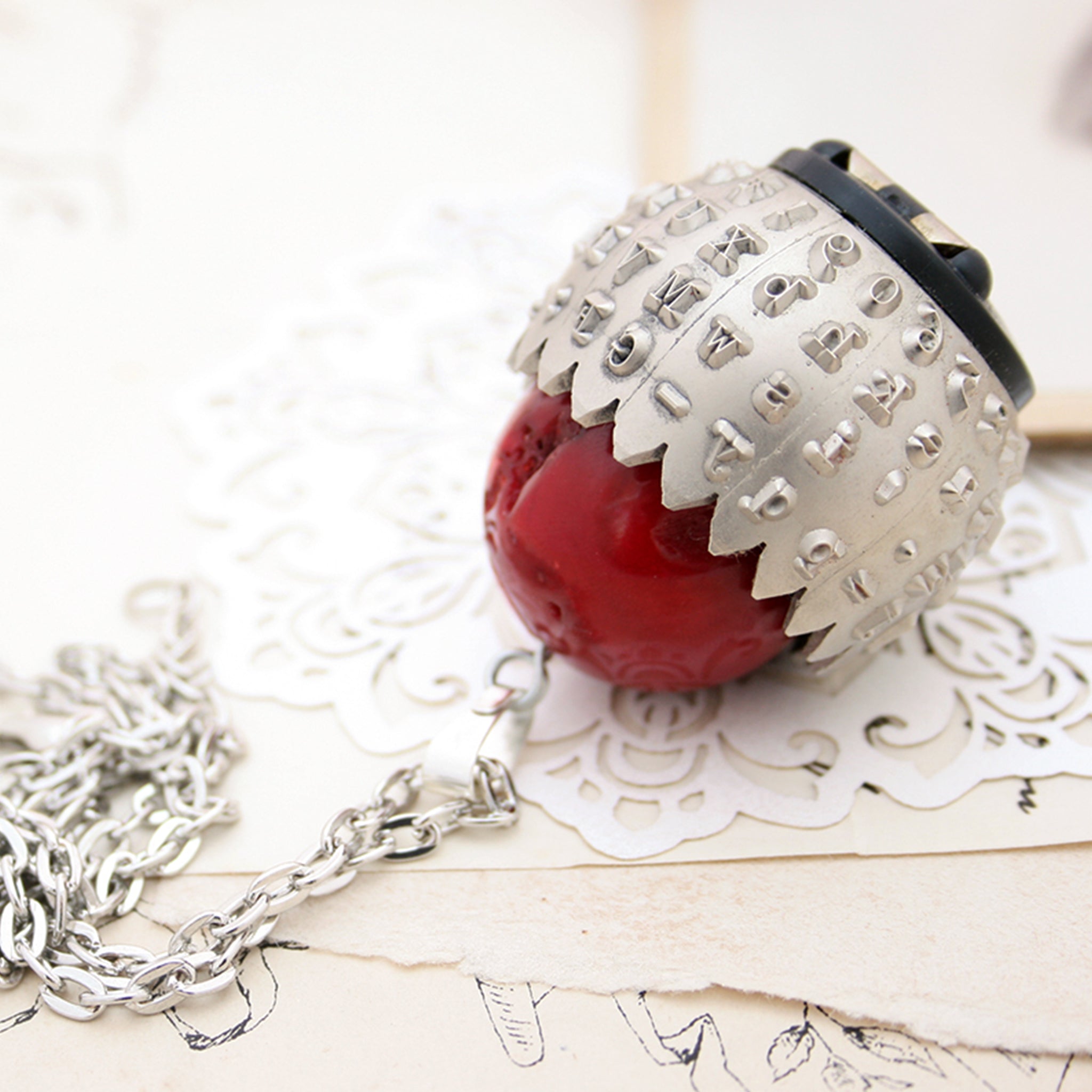 IBM Selectric typewriter font ball with large coral bead turned into eye catching necklace