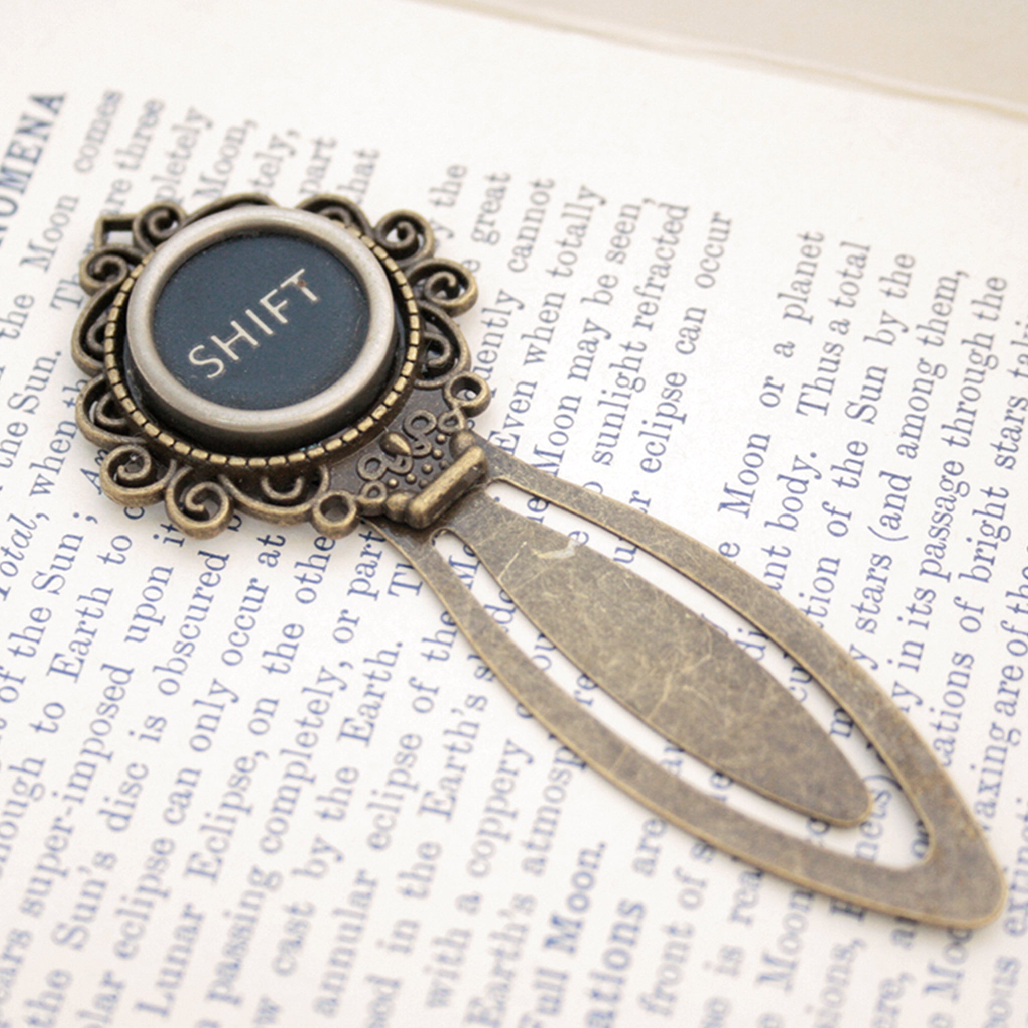 Metal bookmark made of real Shift Key from the typewriter in a book