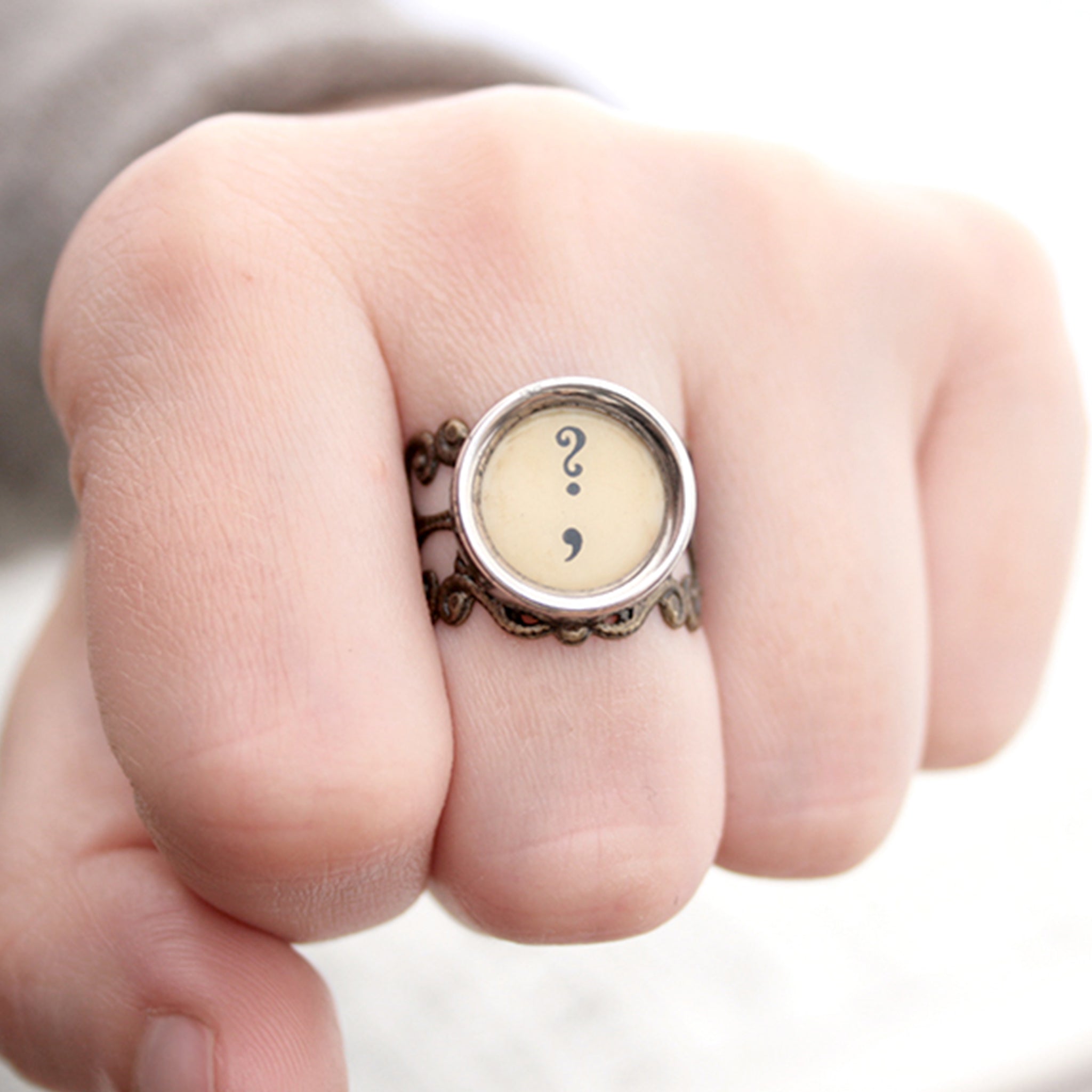 Ring with question mark and comma made of  typewriter key in ivory color worn on hand