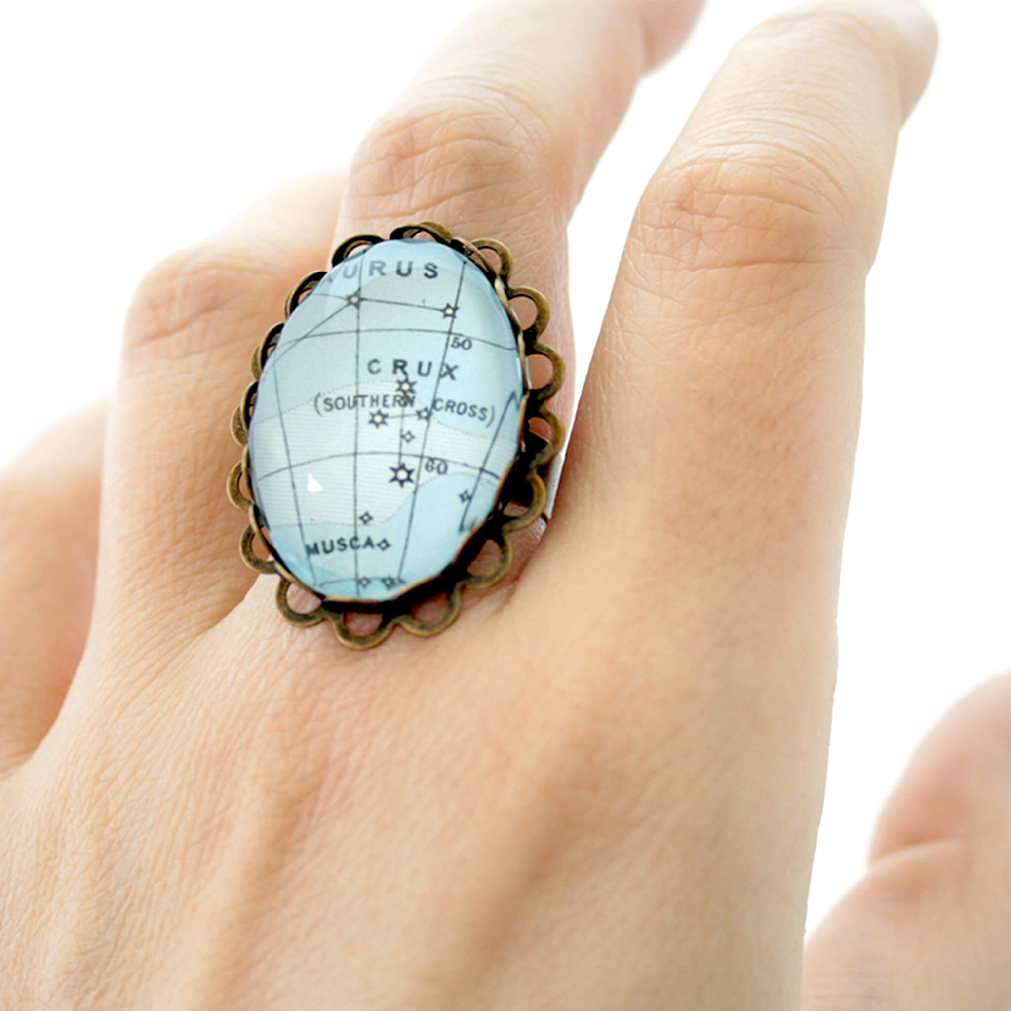 Bronze, oval ring featuring map of heaven with Crux worn on middle finger
