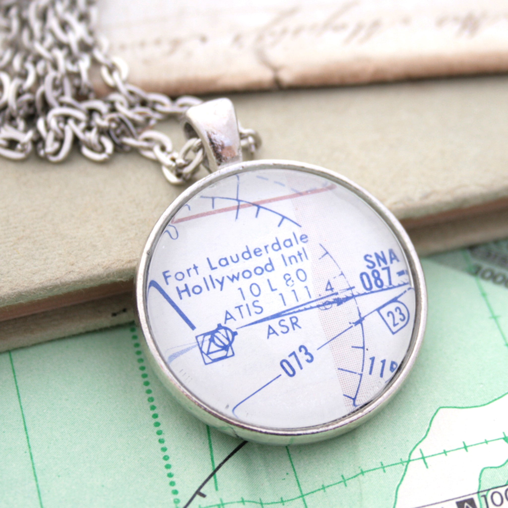 Silver pendant necklace featuring custom pilots chart