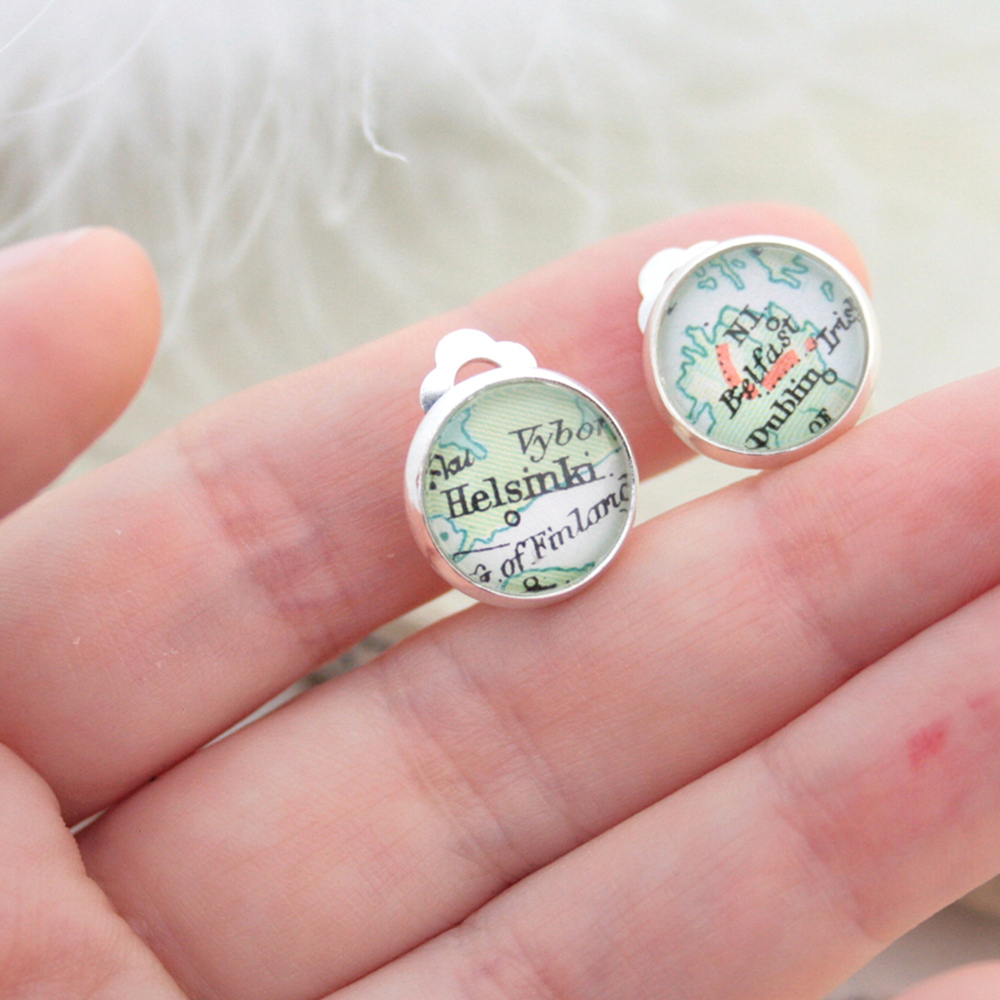hold in hands Custom clip on earrings in silver tone featuring vintage maps