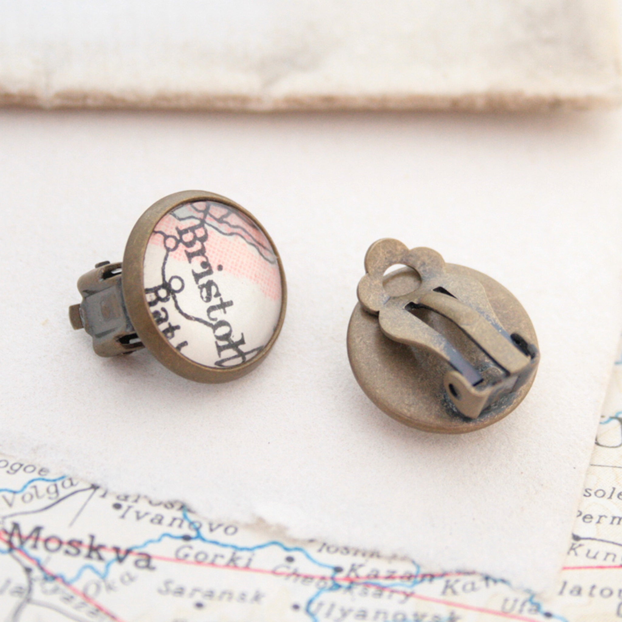 Custom clip on earrings in bronze tone featuring vintage maps