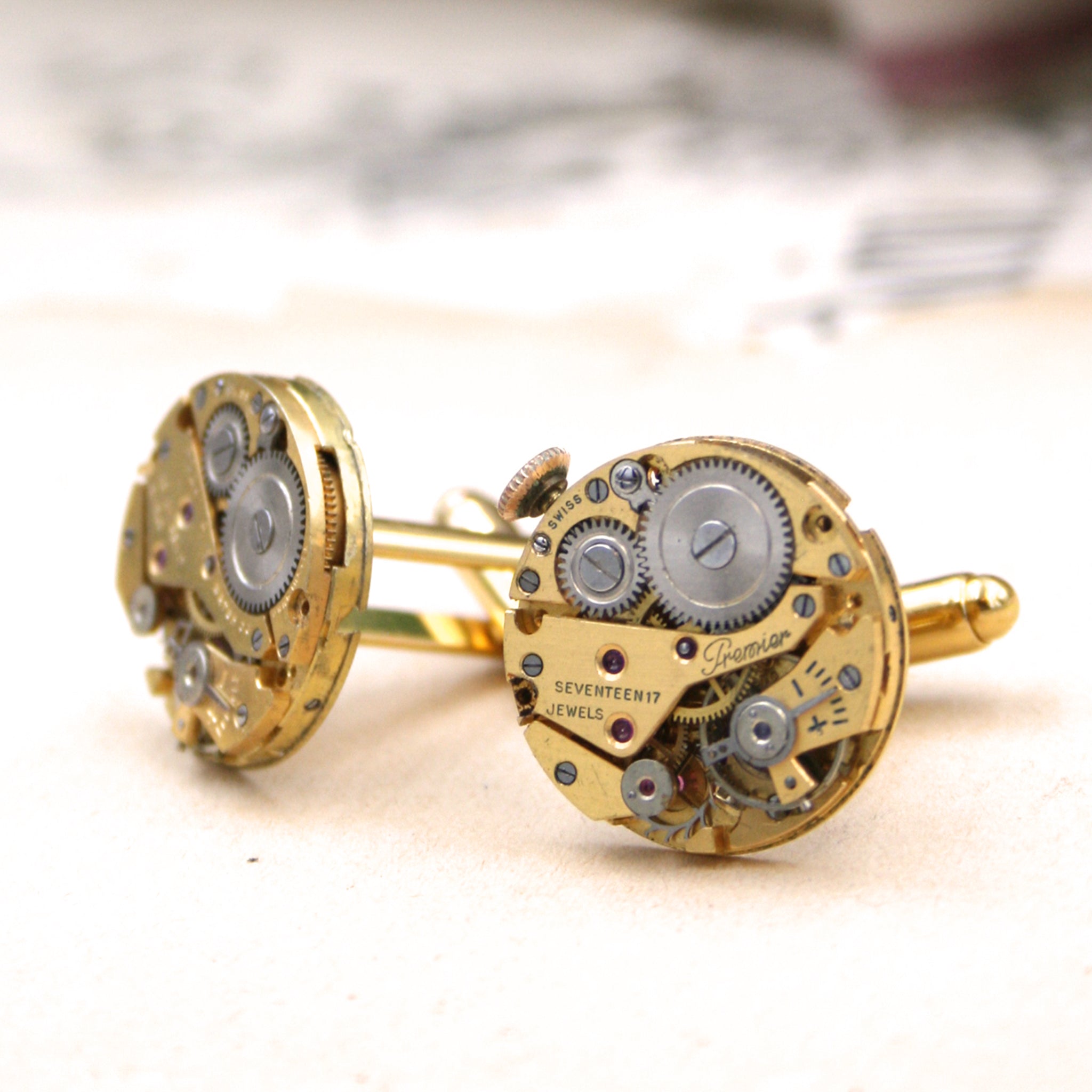gold steampunk cufflinks featuring antique watch movements