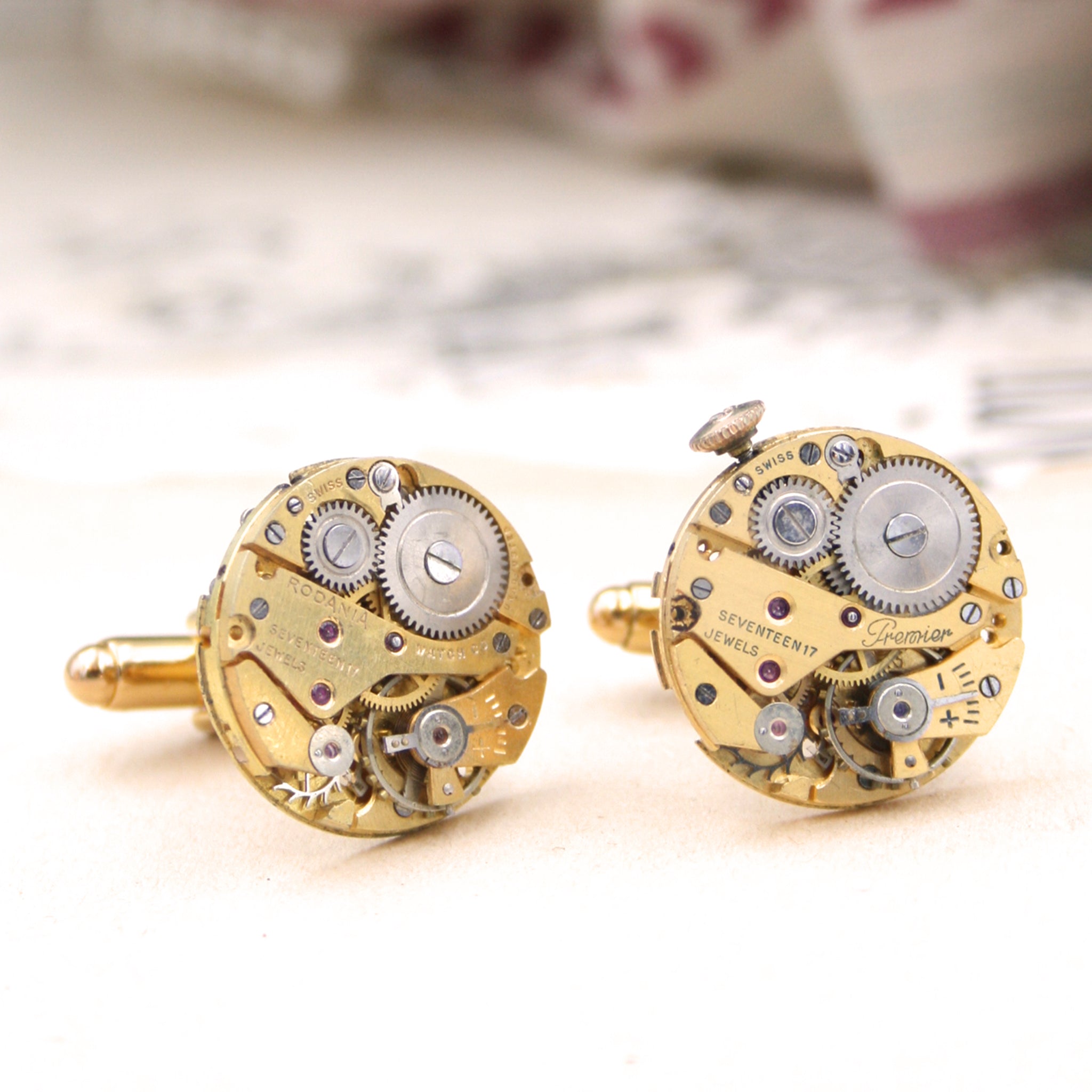 gold steampunk cufflinks featuring antique watch movements