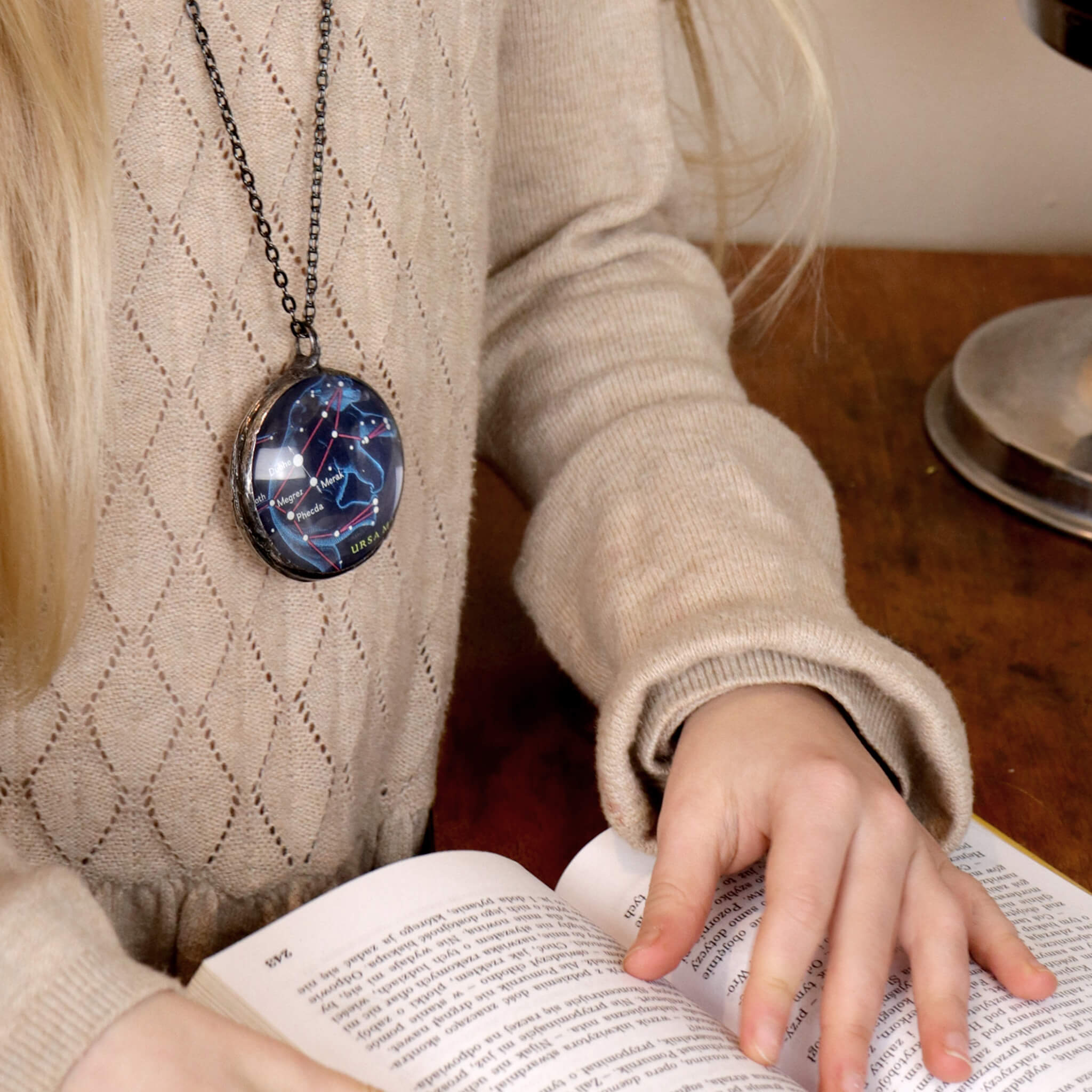 Girl wearing Ursa Major stained glass necklace
