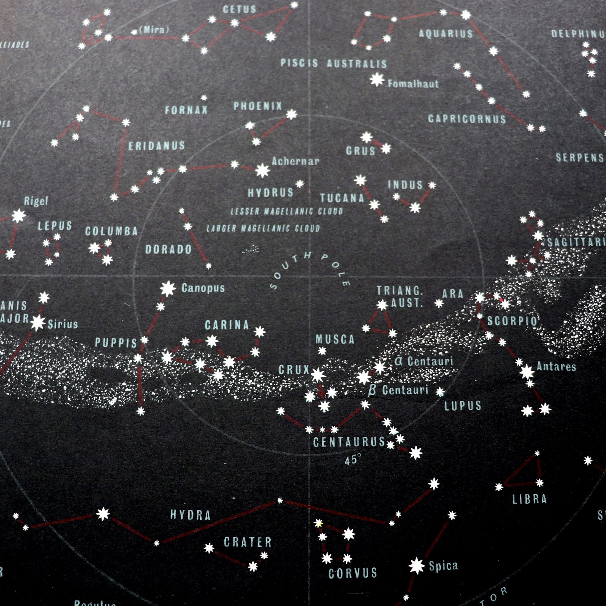 Black map of heavens featuring stars and constellations
