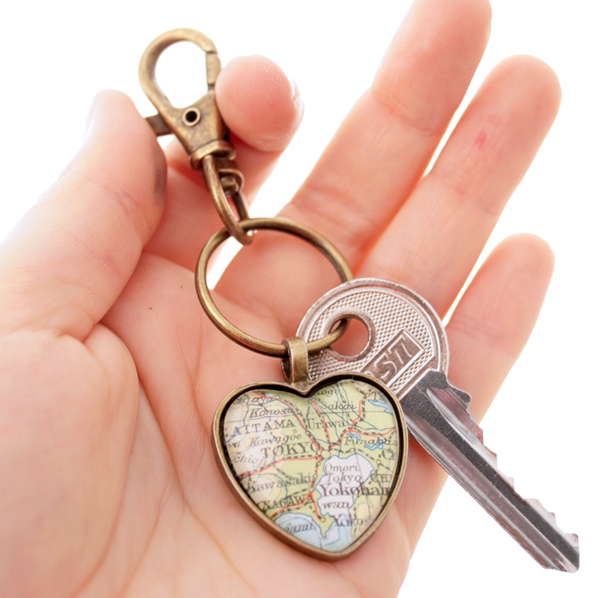 Hold in hand Heart shaped keychain in bronze tone featuring map of Tokyo