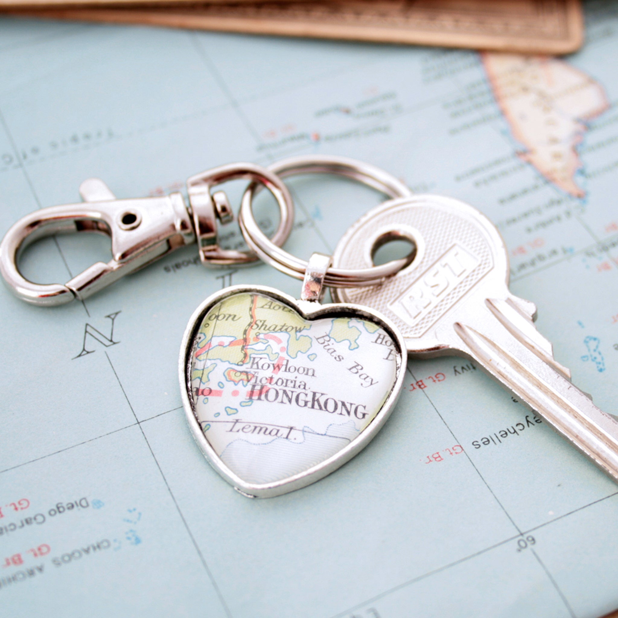 Heart shaped keychain in silver tone featuring map of Hong Kong