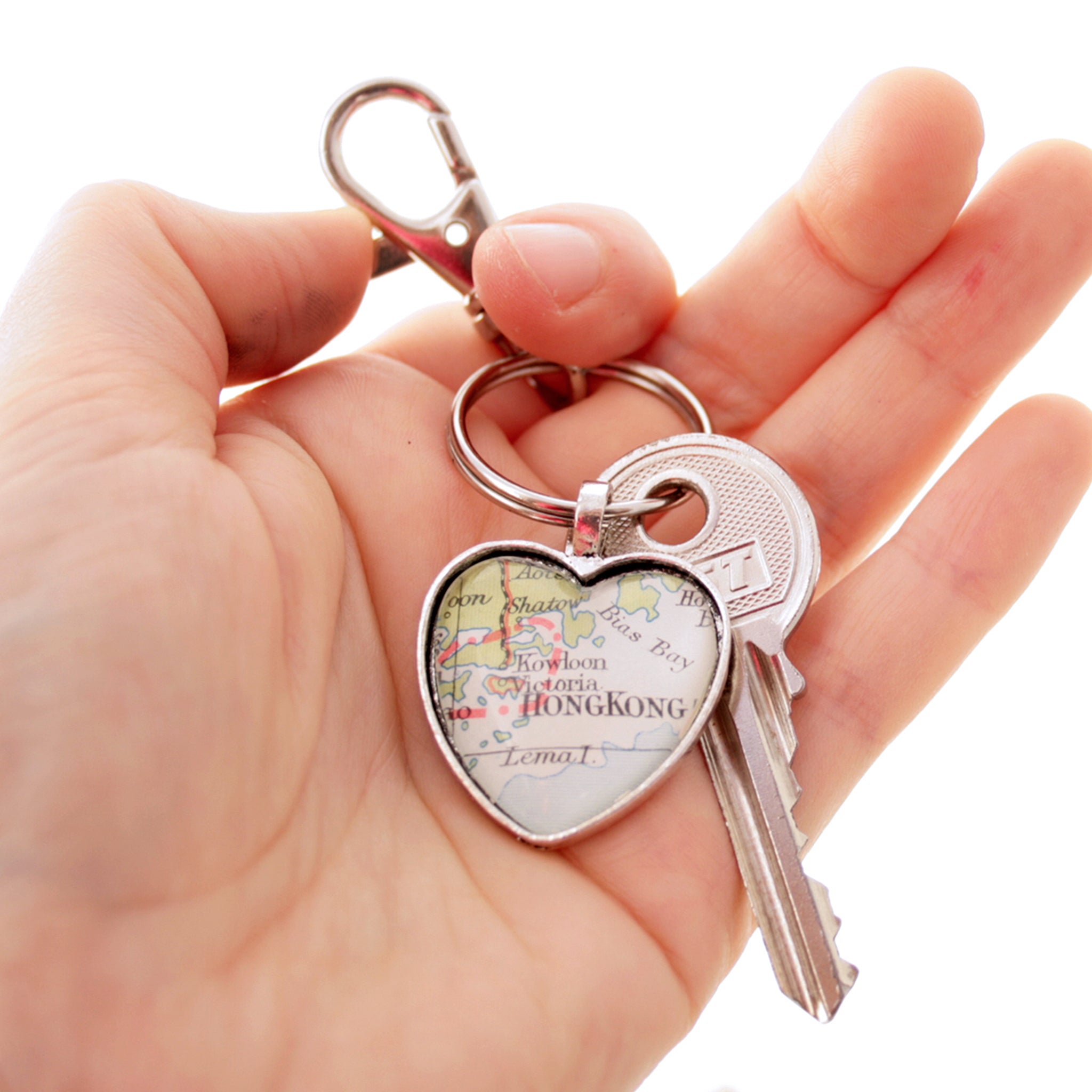 Hold in hand Heart shaped keychain in silver tone featuring map of Hong Kong