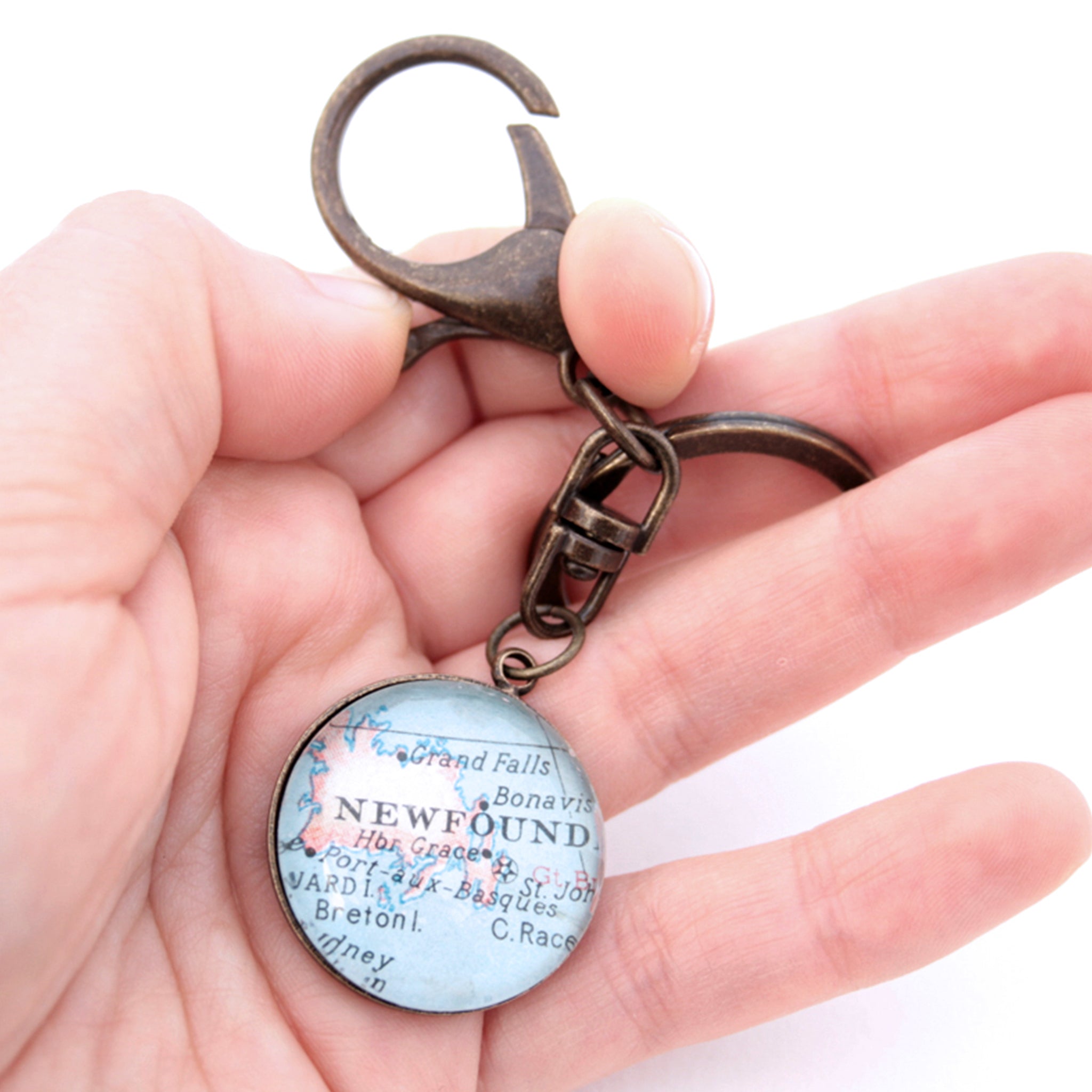 HOld in hand Personalised keyring in antique bronze color featuring map of Newfoundland
