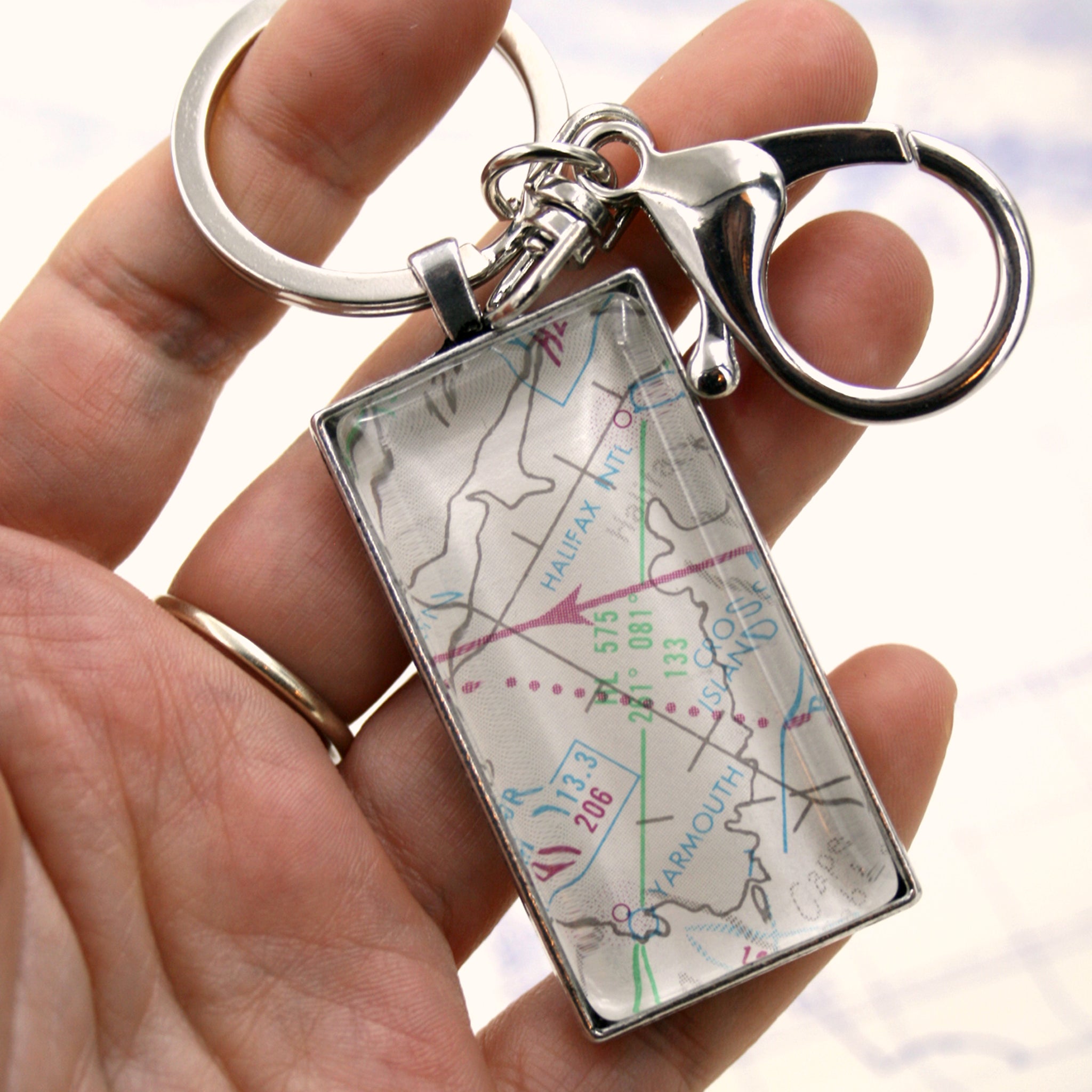 Hold in hand rectangular, silver keychain featuring aeronautical chart 