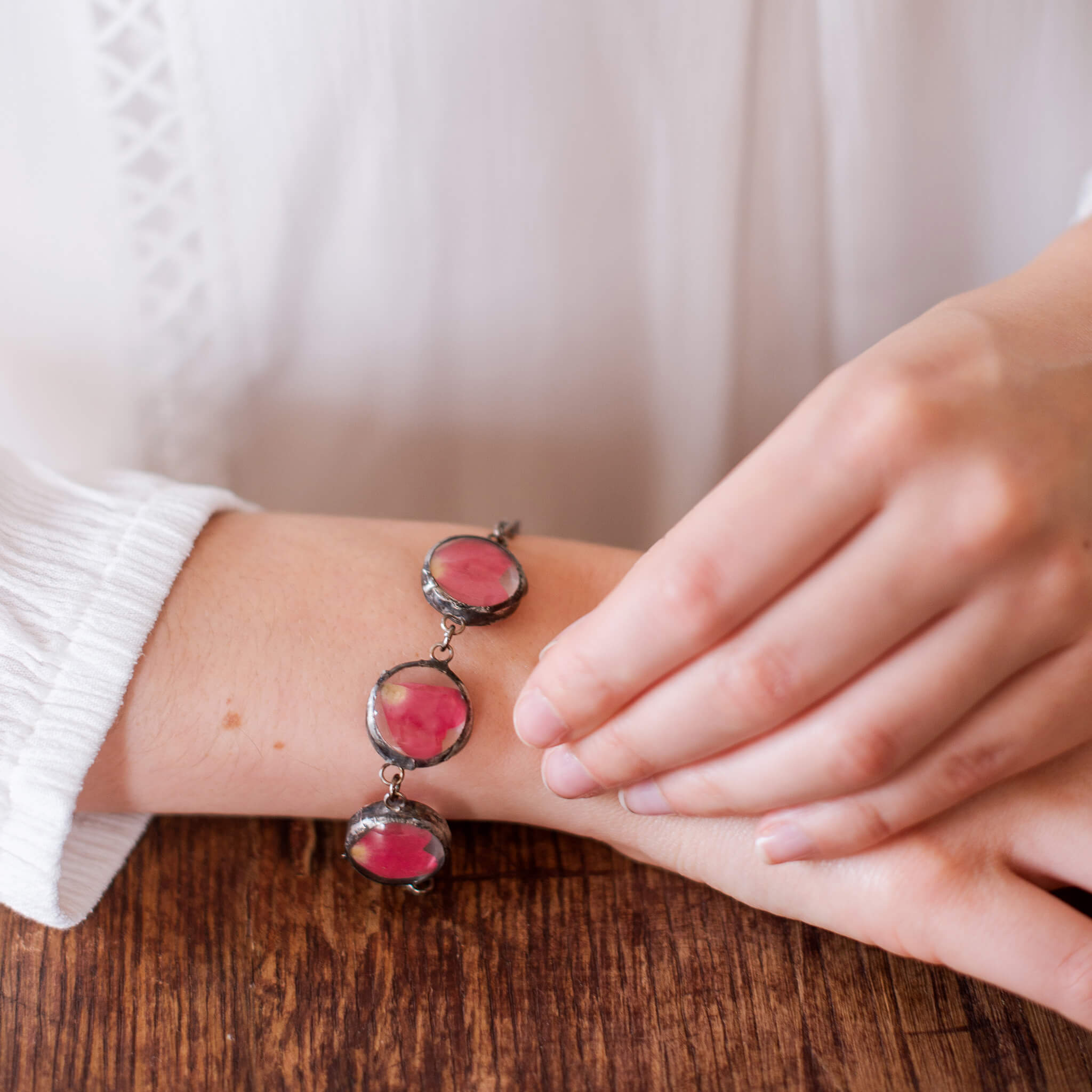 Pressed rose petal bracelet on a wrist