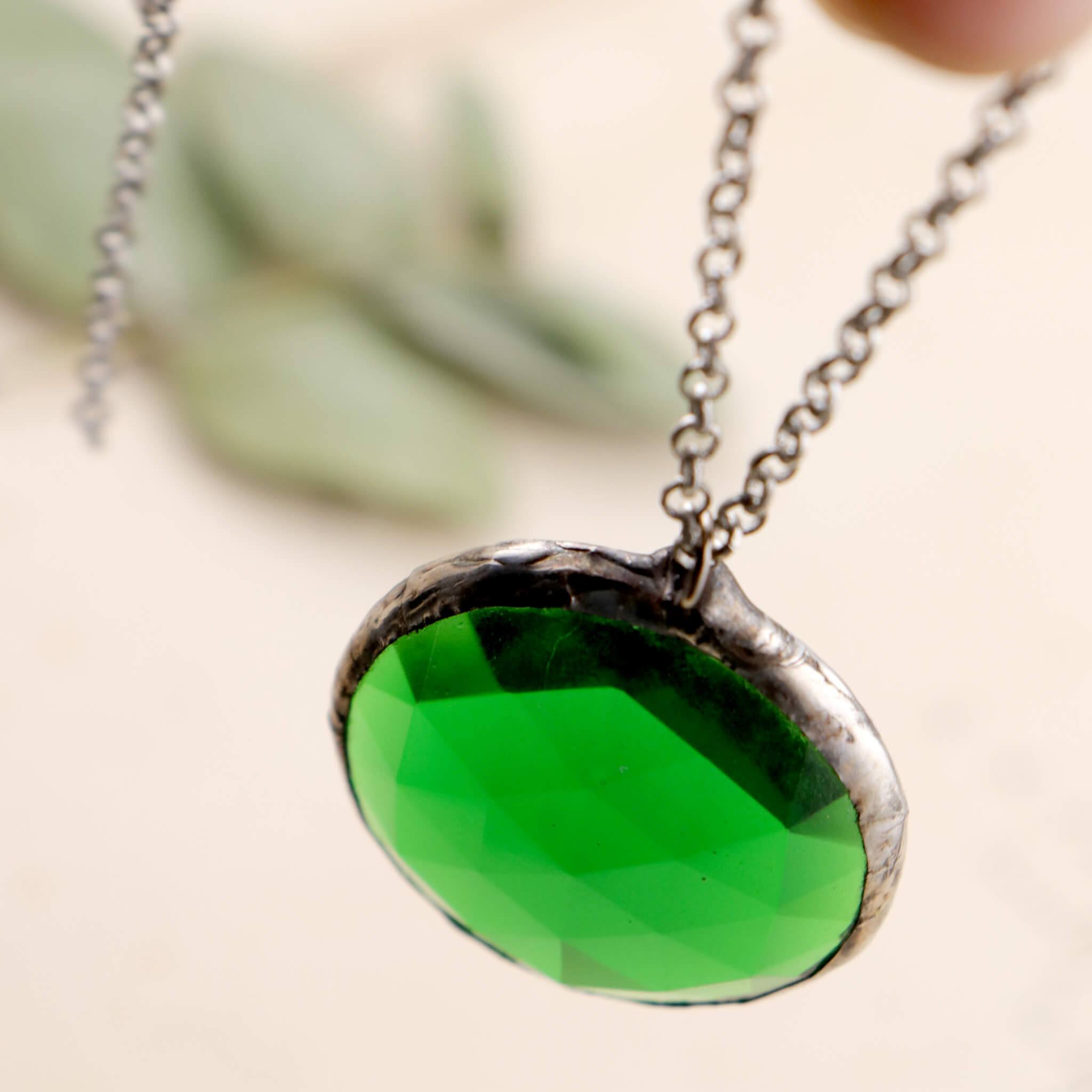 Faceted emerald glass framed into necklace