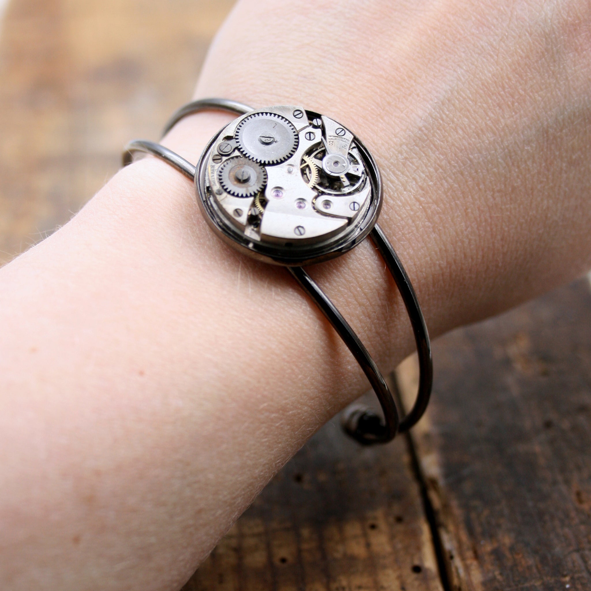 Steampunk open bangle bracelet in gunmetal black tones.