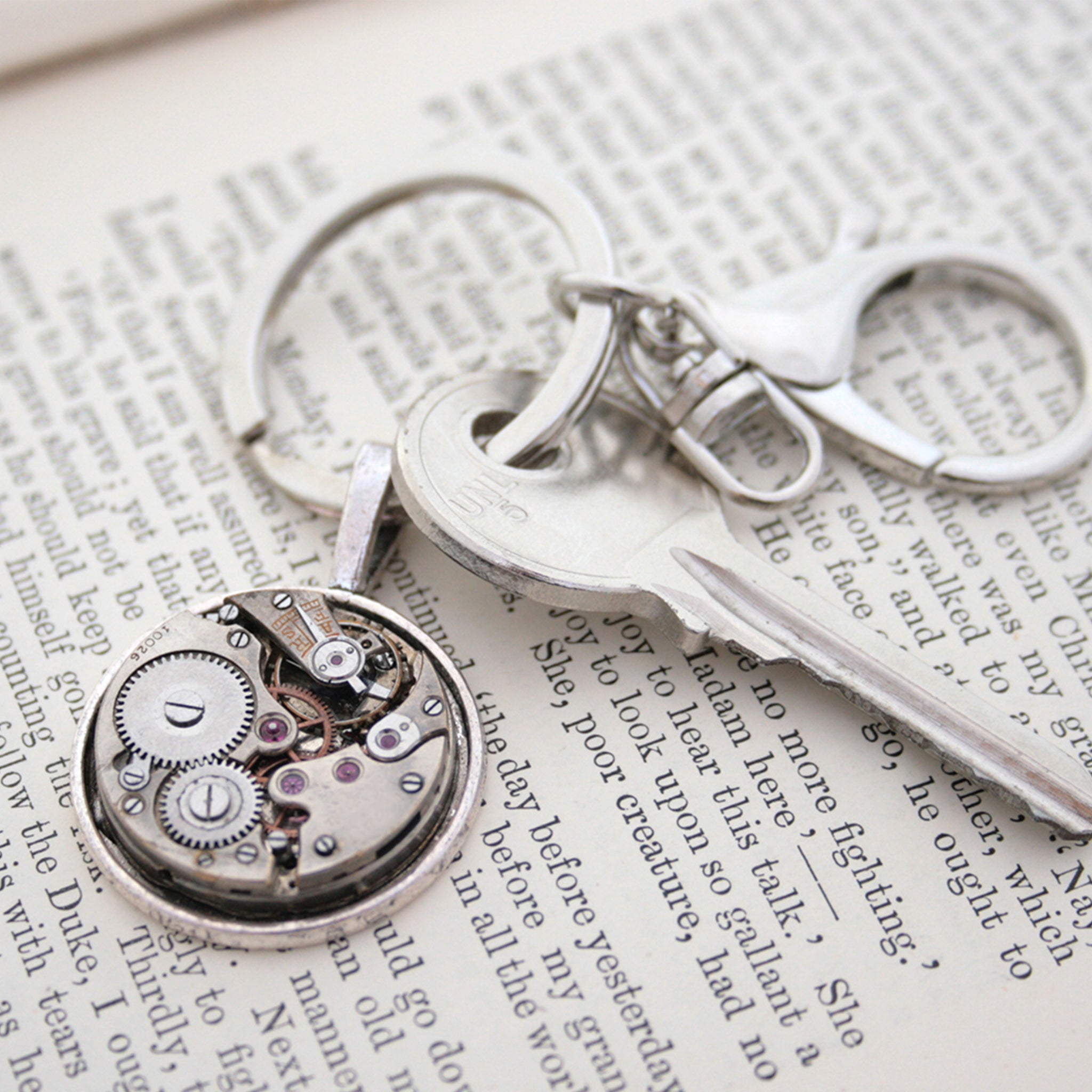 steampunk keyring for man, made of real antique watch movement on metal base in silver tone