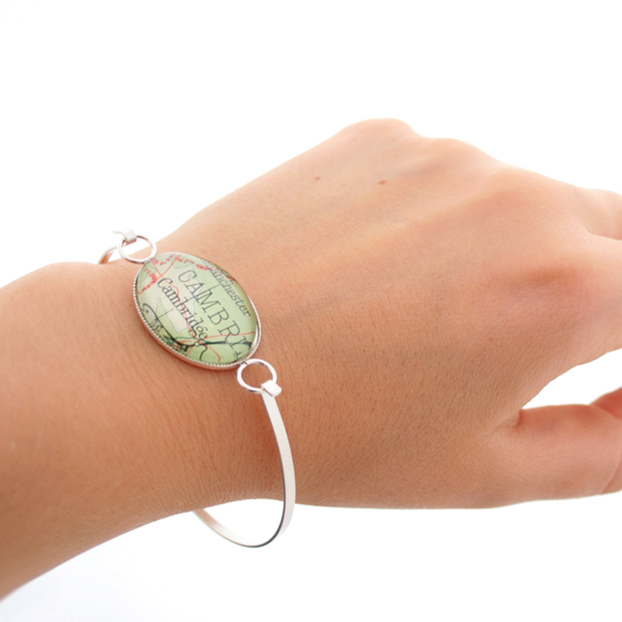 Sterling silver bangle bracelet featuring map of Cambridge worn on hand
