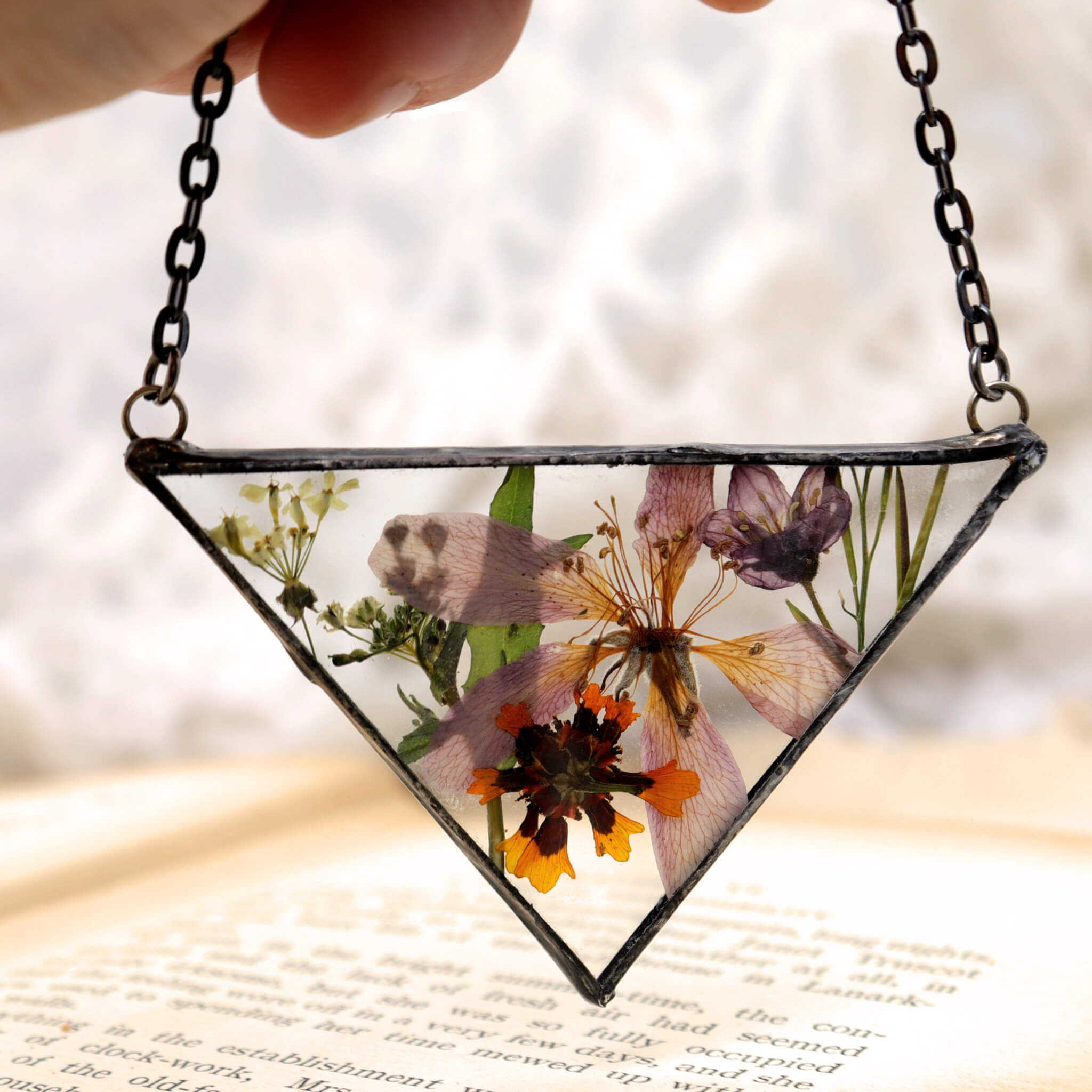 Necklace of a mix of pressed flowers in triangular soldered glass