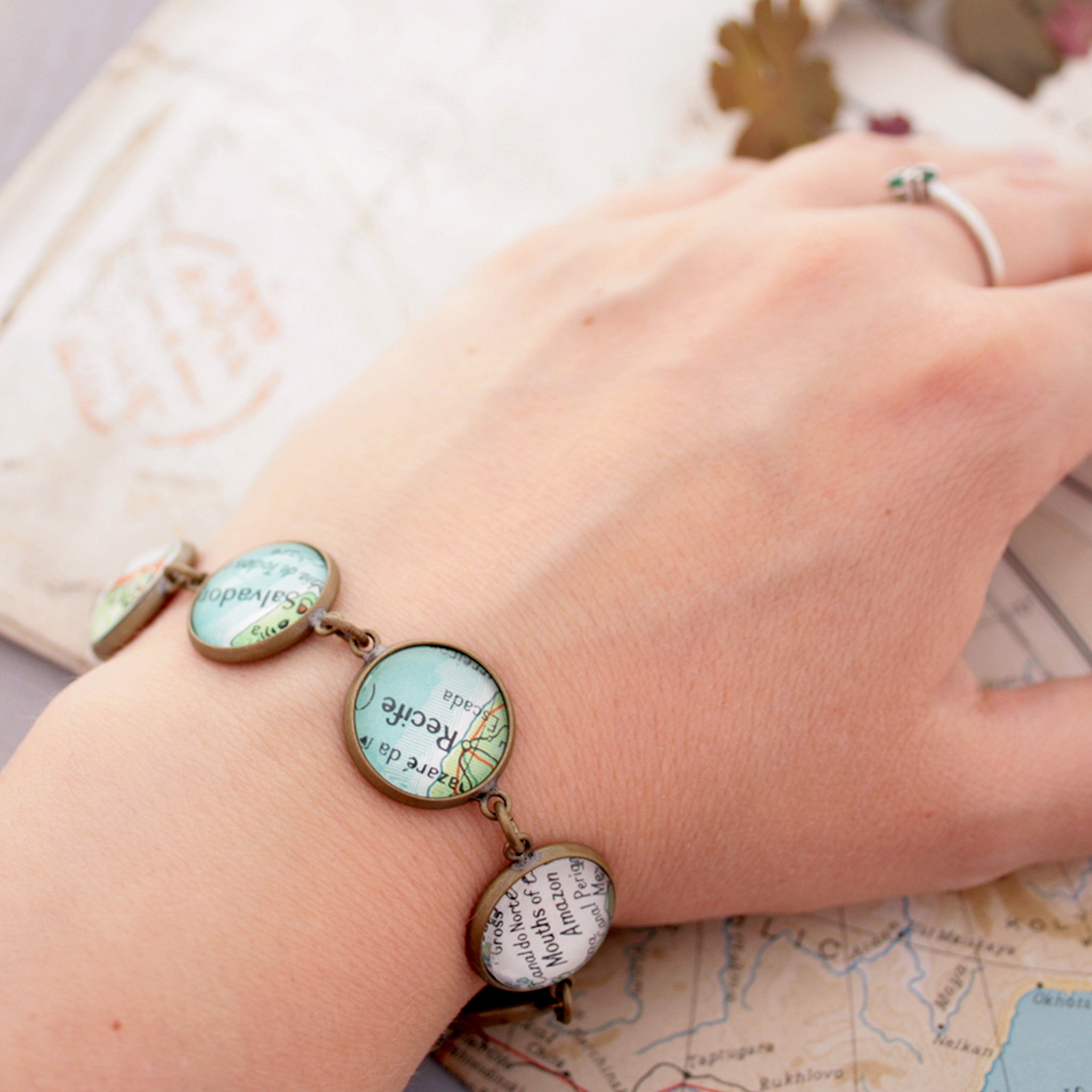 Worn on hand Antique bronze beaded bracelet featuring different map locations