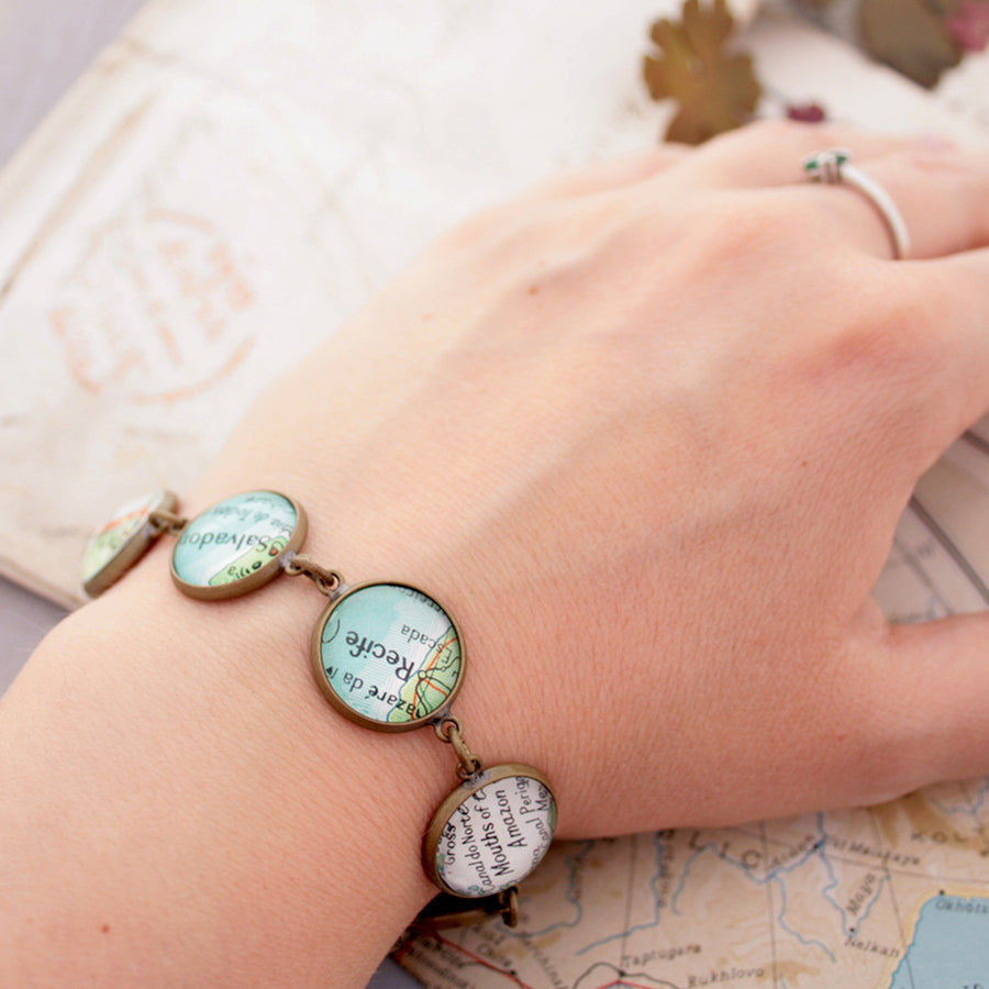 Antique copper beaded bracelet featuring different map locations
