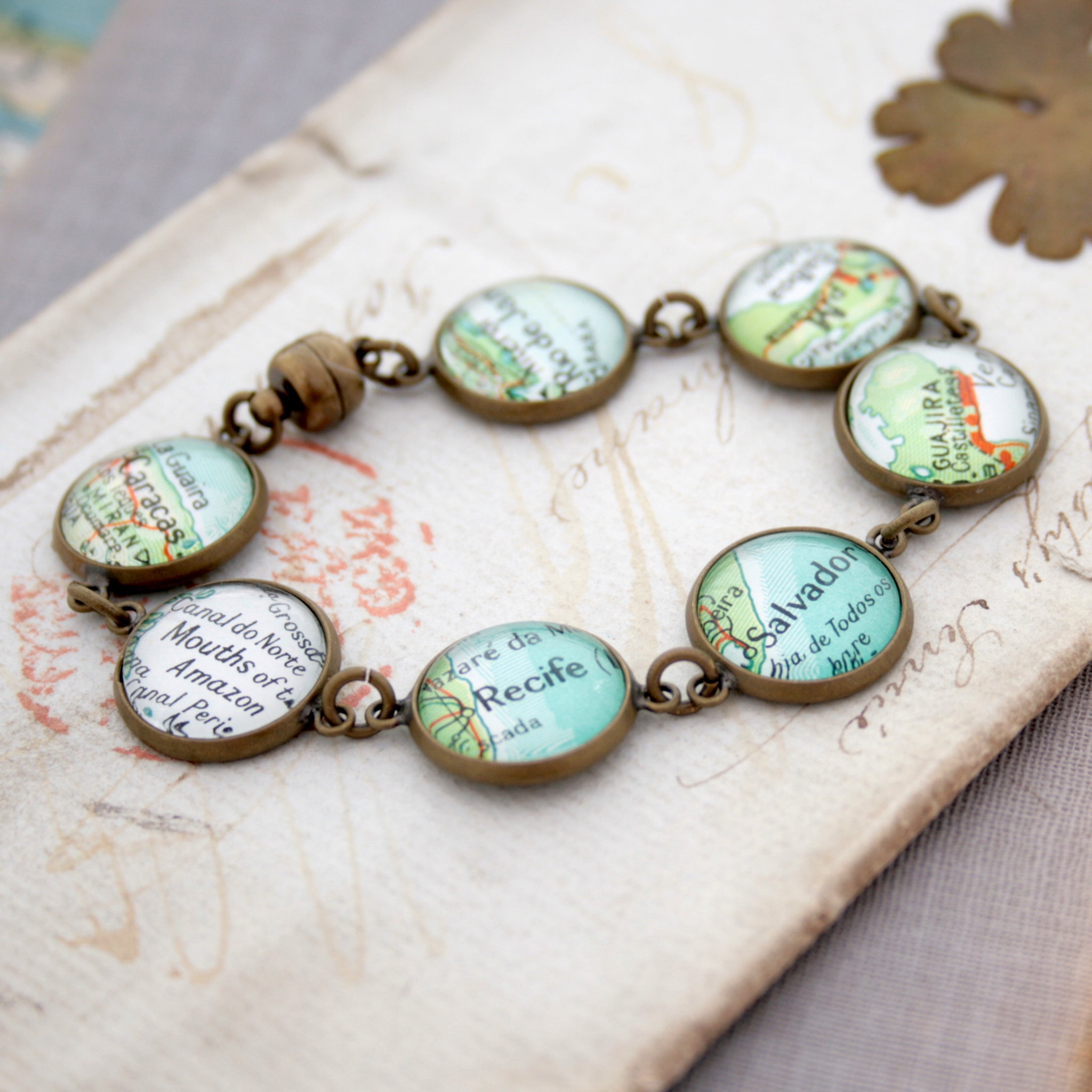Antique bronze beaded bracelet featuring different map locations